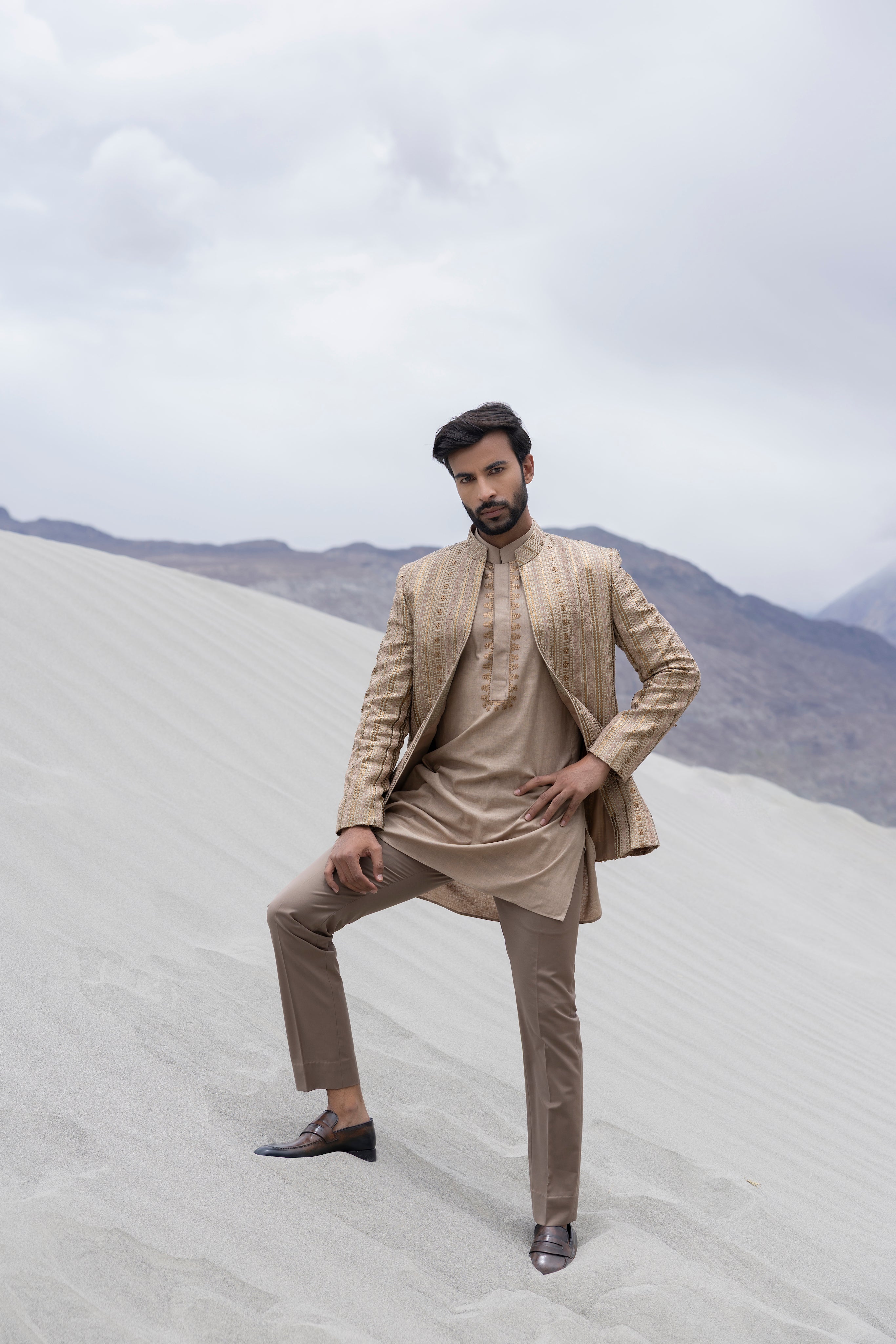 Beige front open silk jaquard indowestern jacket with monotone hand-embroidery paired with an embroidered kurta and pants.