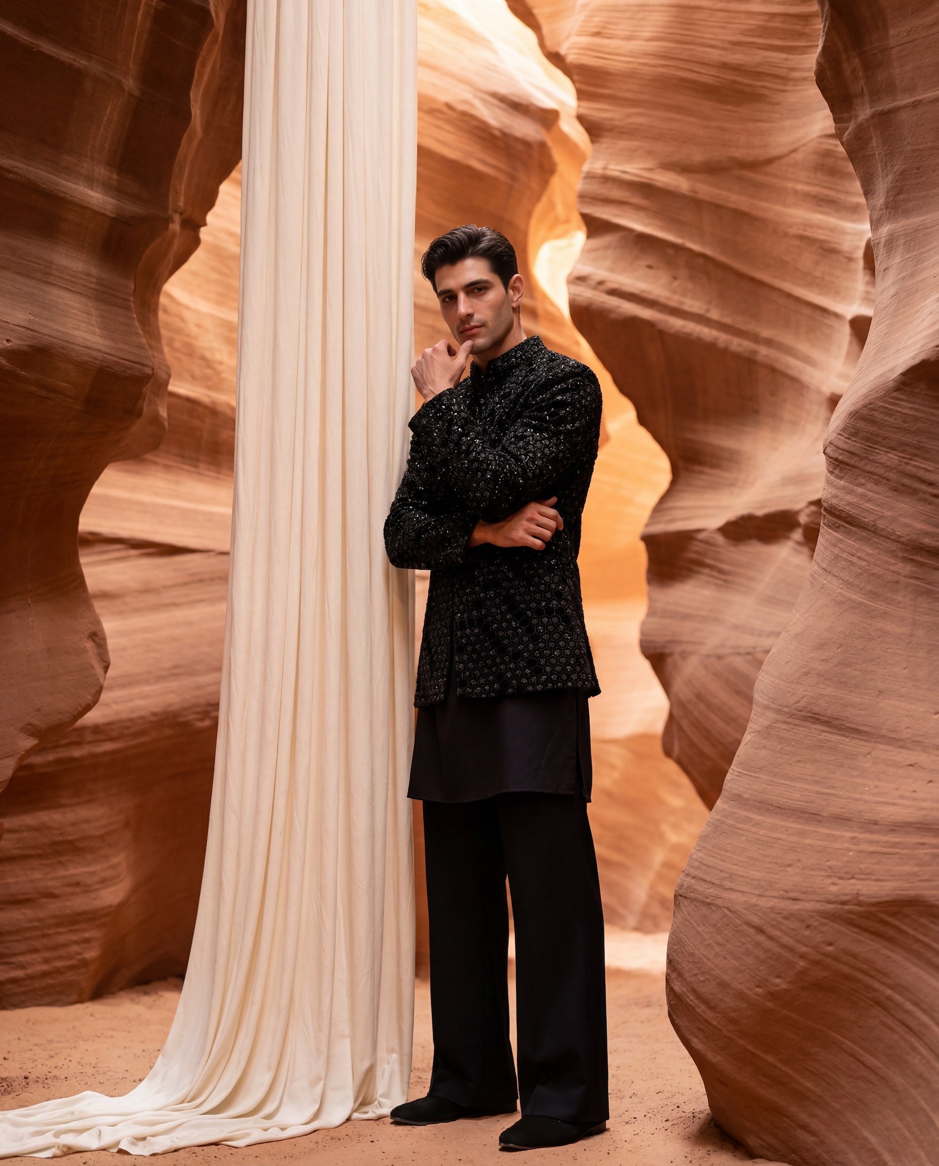 Black velvet Indo-Western jacket with honey-comb pattern embroidery detailing, paired with a cotton modal kurta and poly-wool pants.