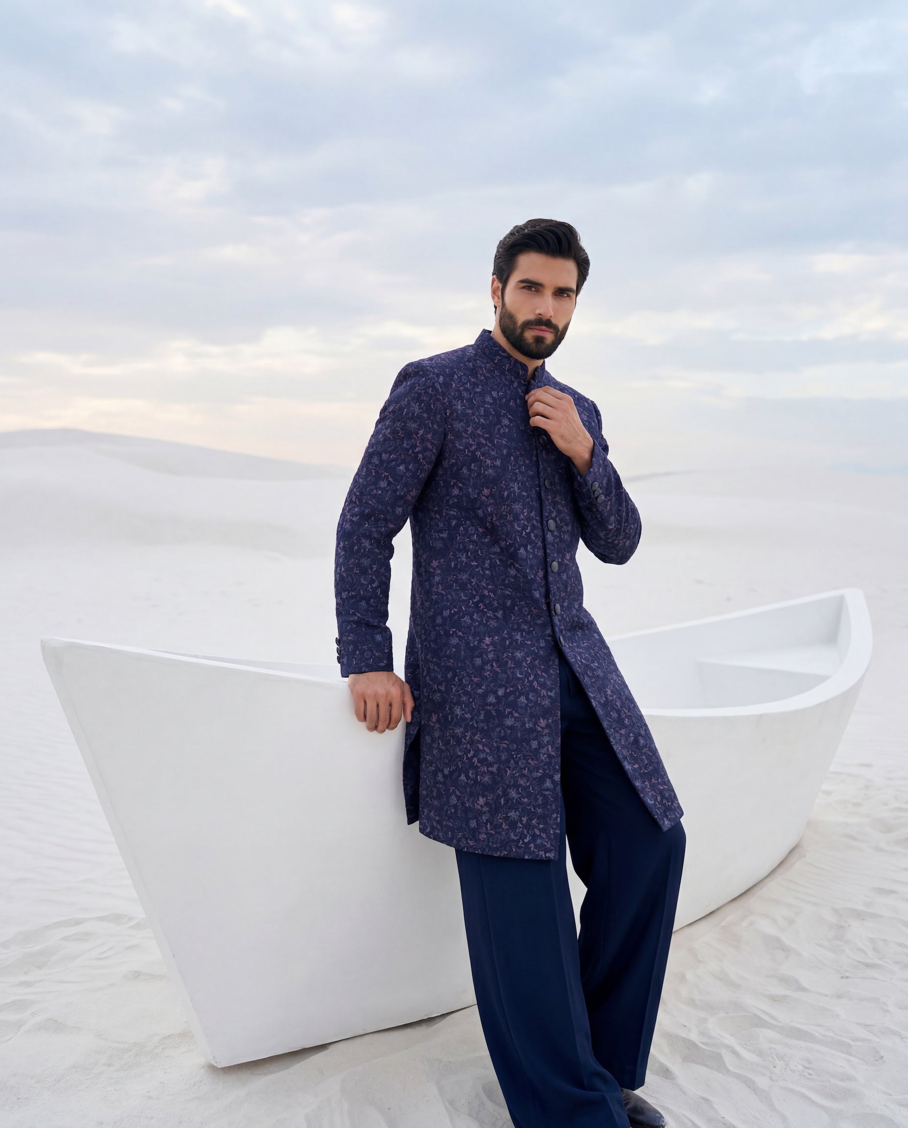Navy blue Pashmina sherwani with intricate multi-coloured embroidery detailing, paired with matching knit pants.