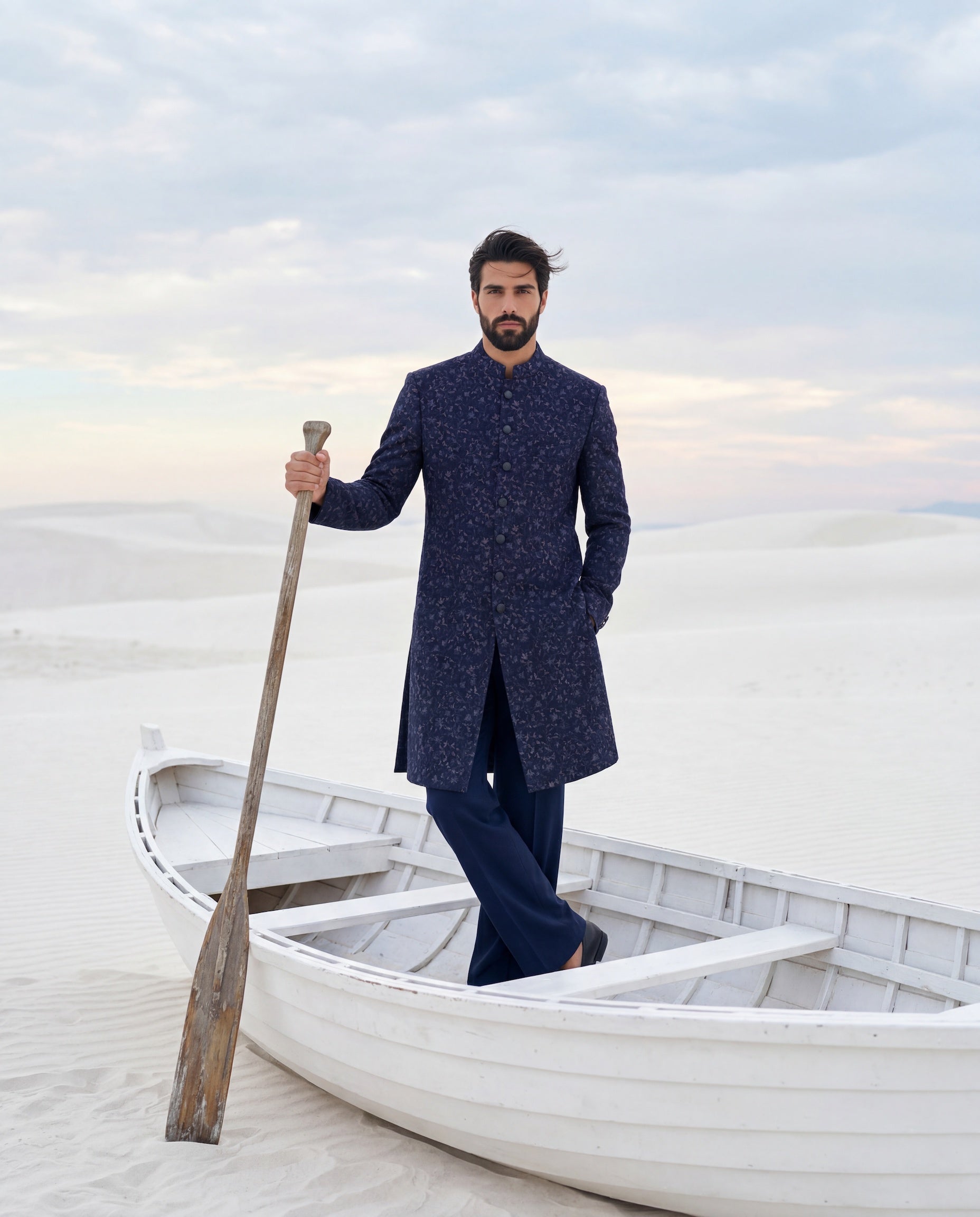 Navy blue Pashmina sherwani with intricate multi-coloured embroidery detailing, paired with matching knit pants.