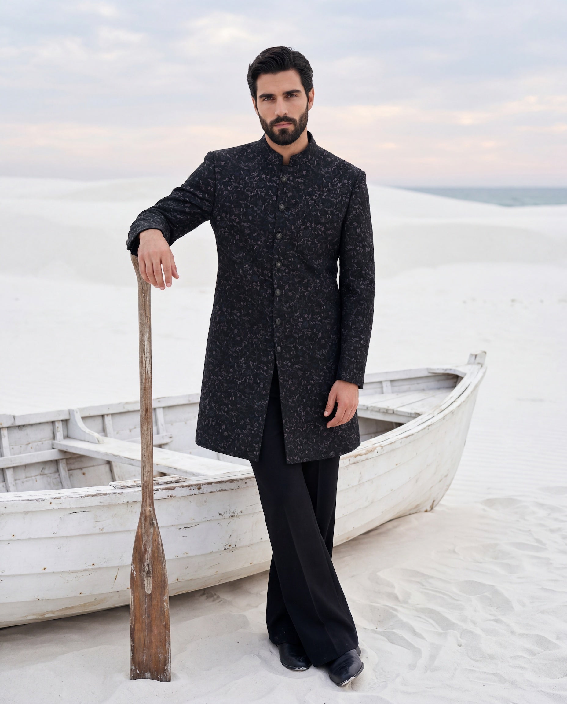 Dark olive green Pashmina sherwani with intricate multi-coloured embroidery detailing, paired with matching knit pants.