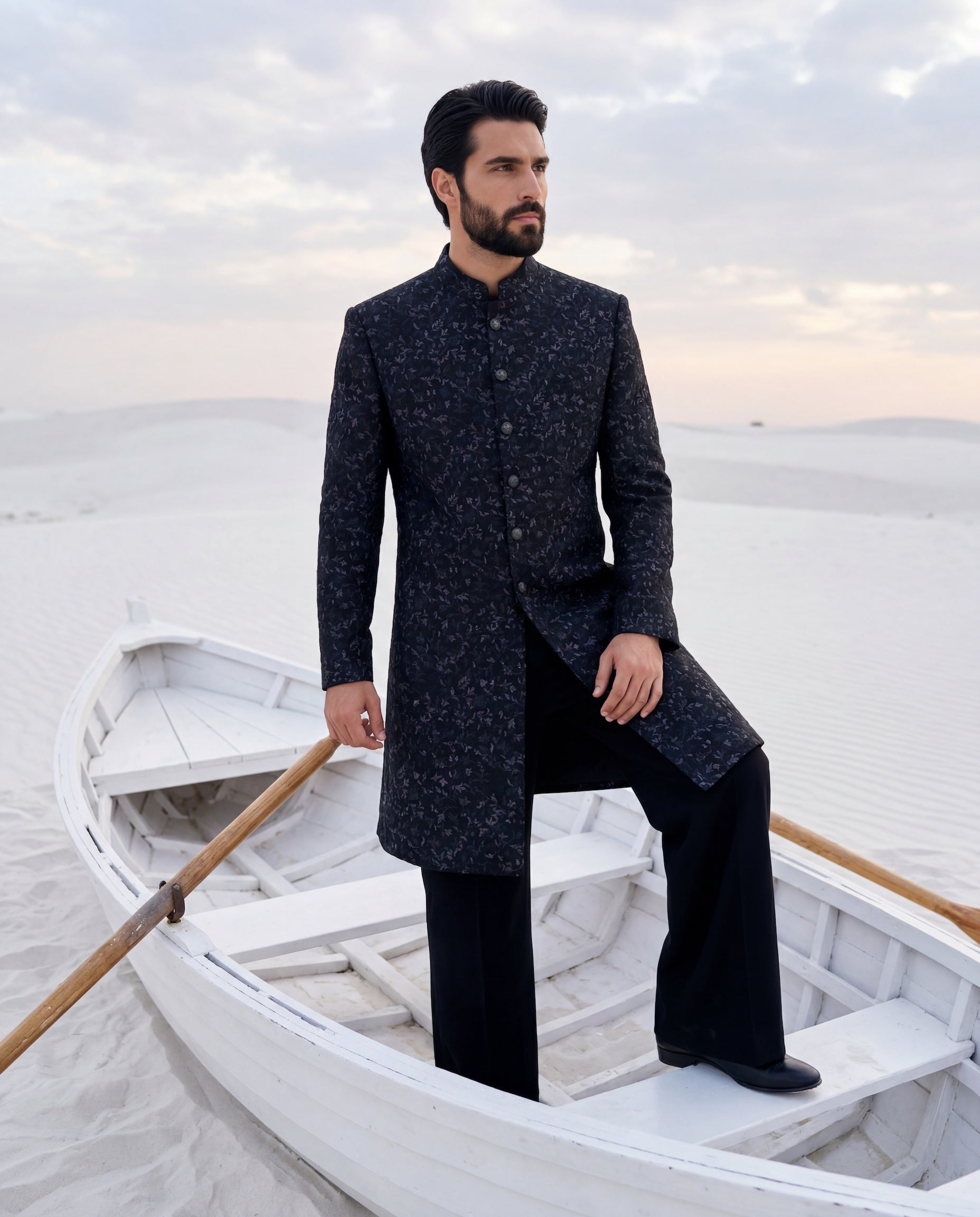 Dark olive green Pashmina sherwani with intricate multi-coloured embroidery detailing, paired with matching knit pants.