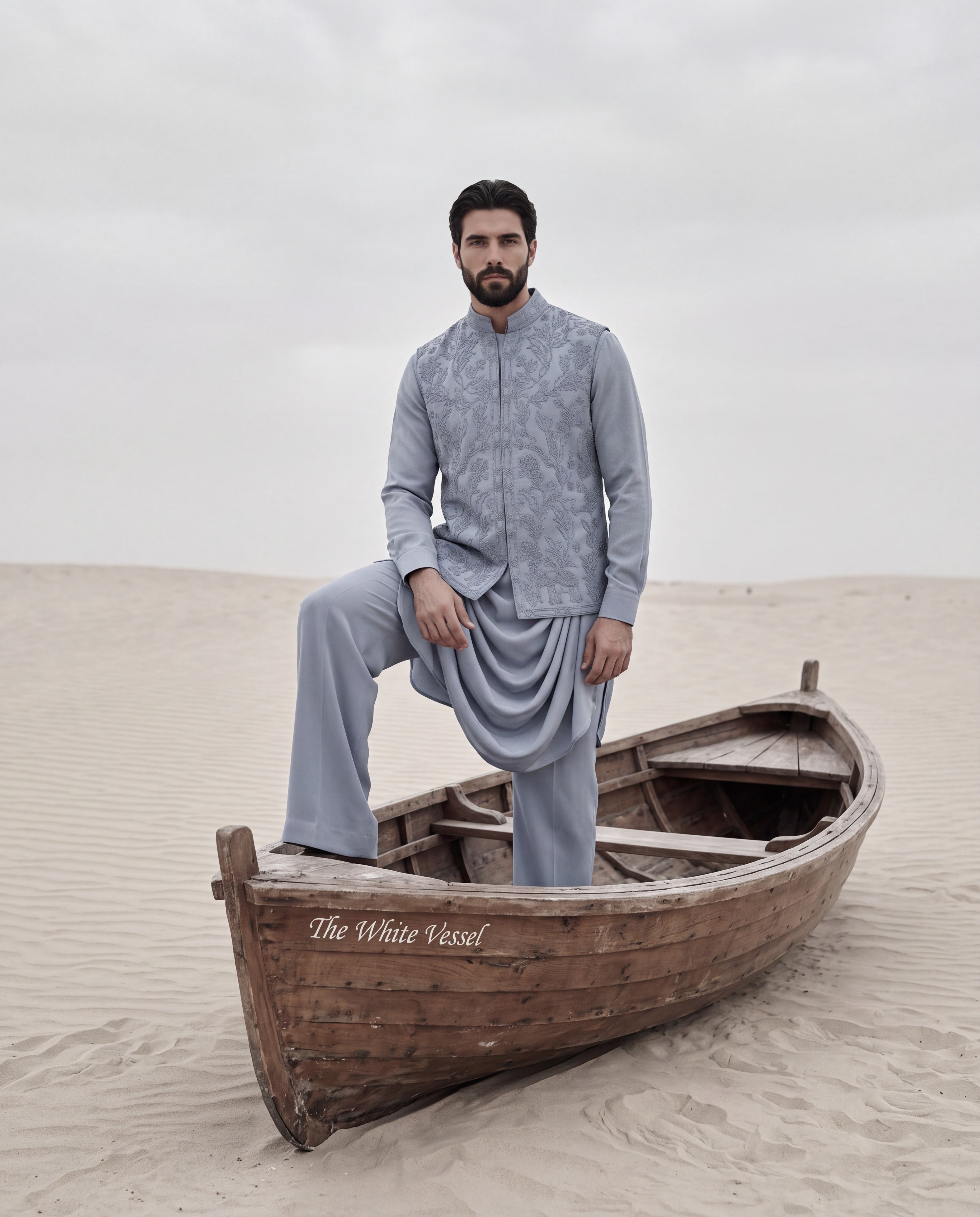Powdered blue waistcoat with monotone hand embroidery detailing, paired with a draped knit kurta and matching plazzo pants.