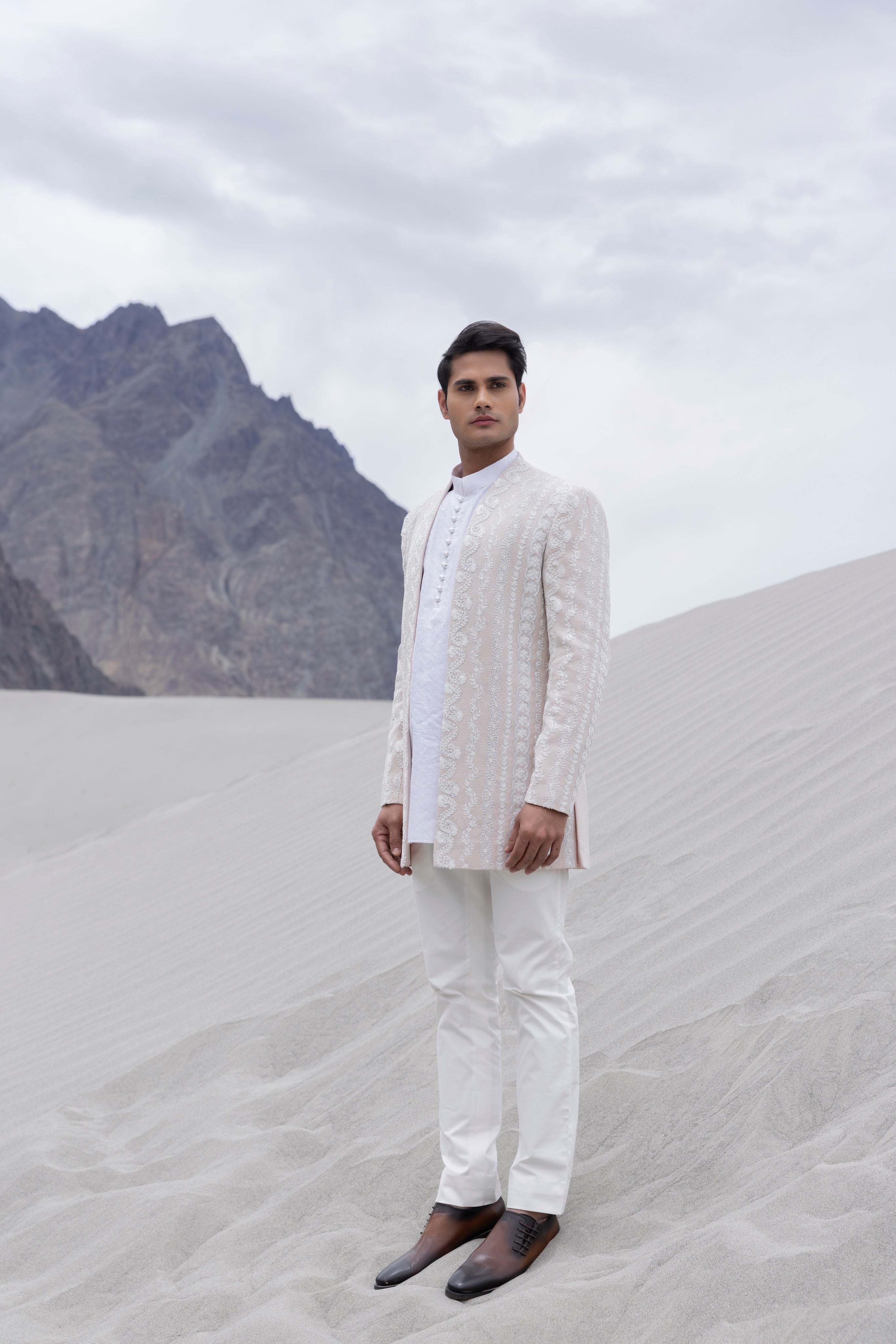 Baby Pink front open  indowestern jacket with ivory hand-embroidered motifs paired with an embroidered silk ivory kurta and  pant.