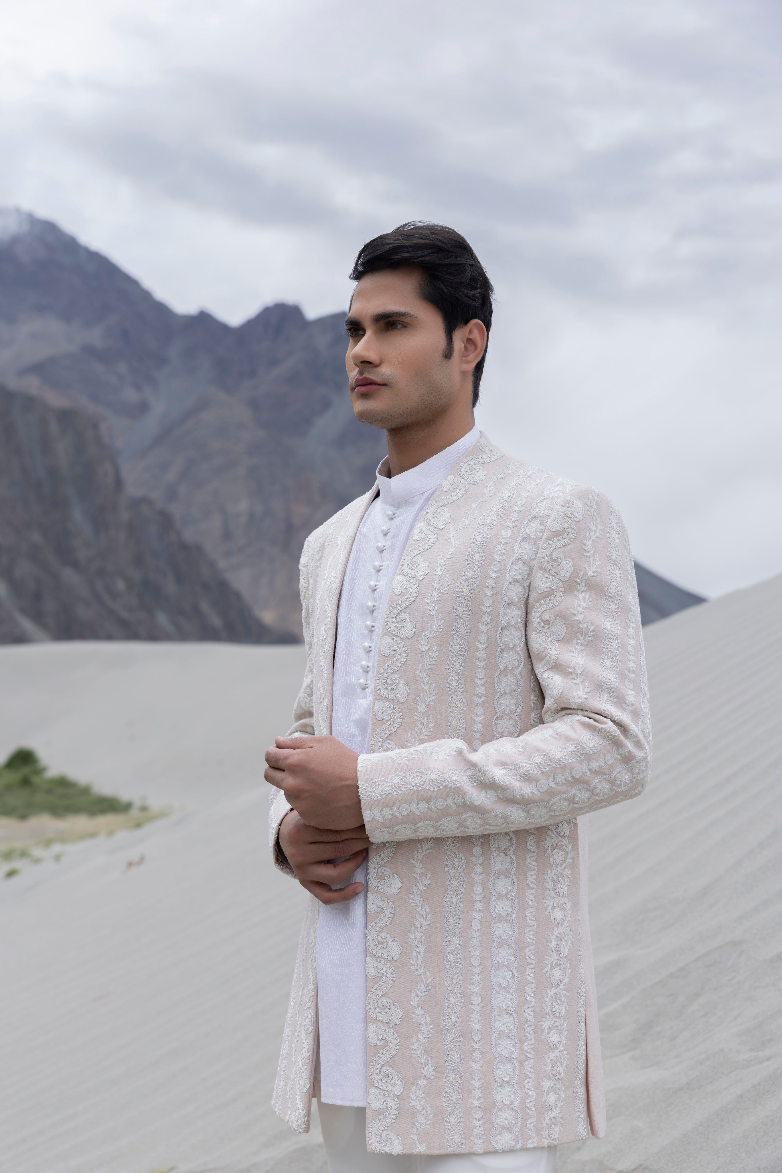 Baby Pink front open  indowestern jacket with ivory hand-embroidered motifs paired with an embroidered silk ivory kurta and  pant.