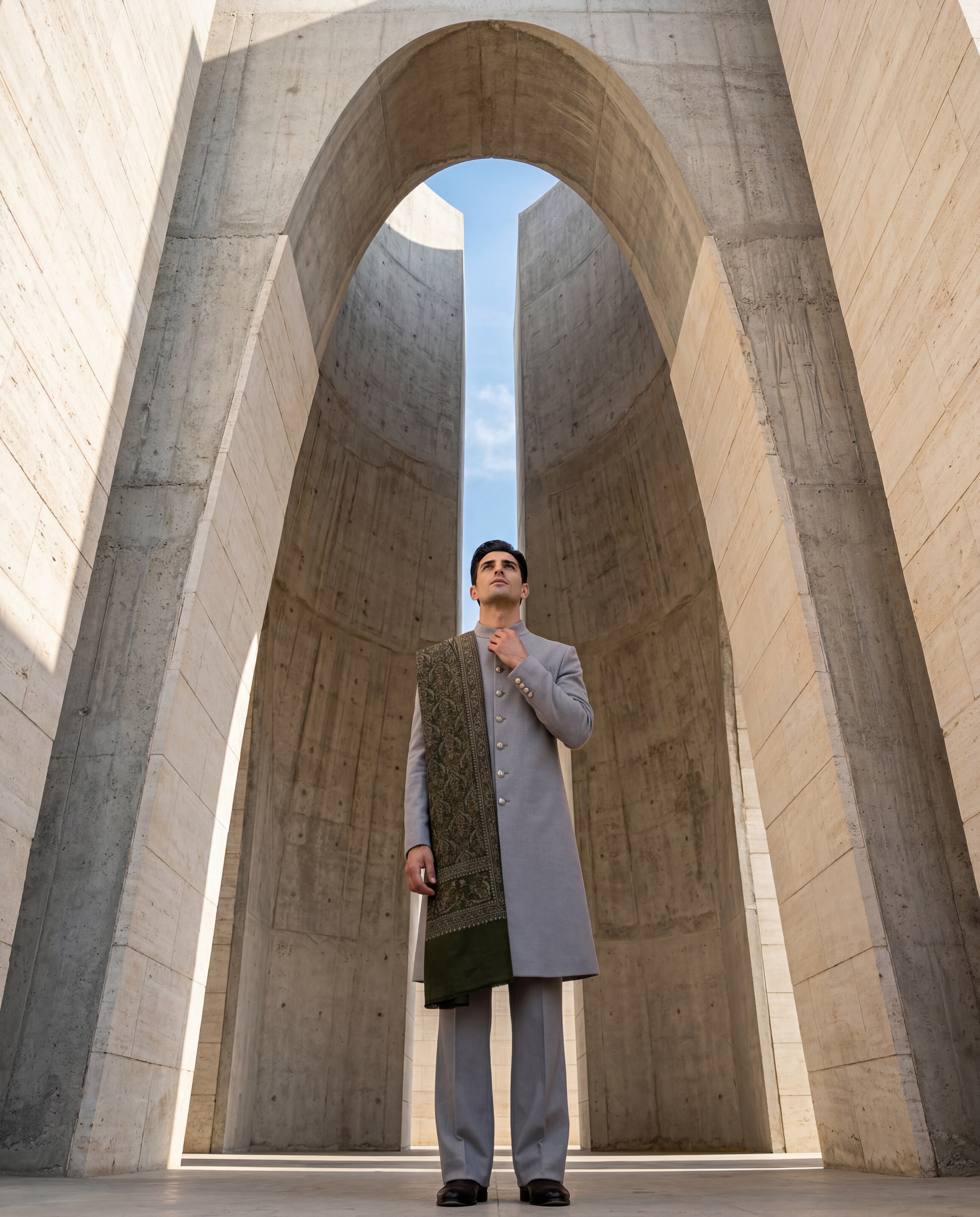 Grey Pashmina sherwani featuring contrast buttons along the front, paired with matching pashmina pants and a pashmina stole with intricate olive toned Kashmiri hand-embroidery all over.