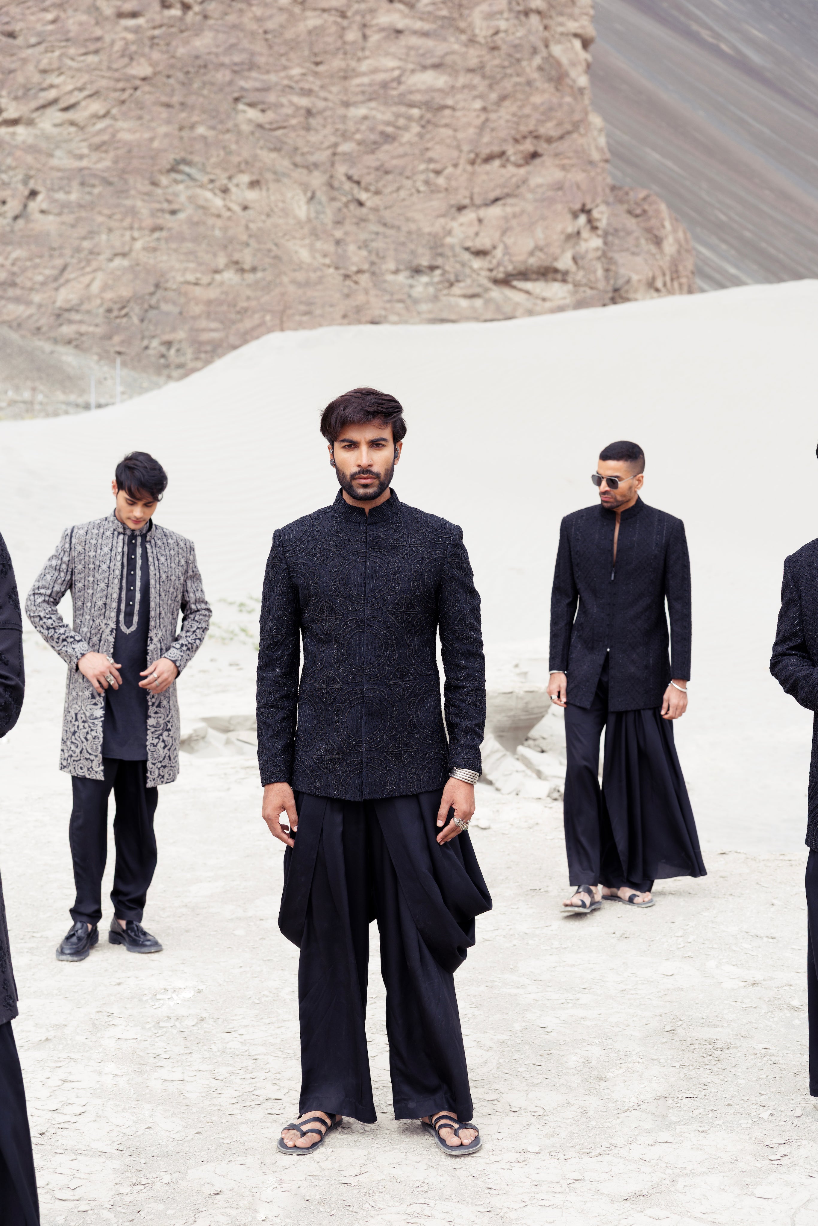 Black crochet short indowestern jacket with monnotone hand-embroidery paired with a dhoti style plazo.