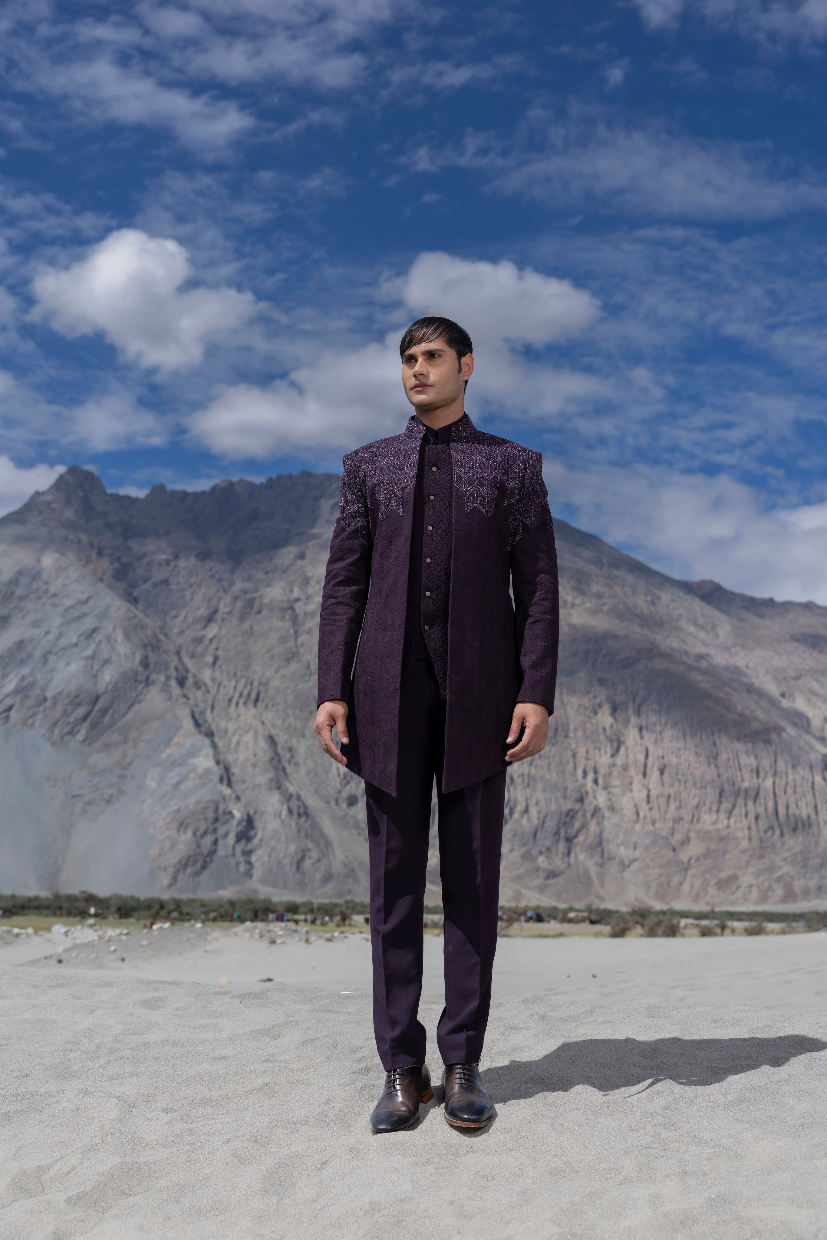 Purple crochet hand-embroidered open indowestern jacket paired with a matching crochet waistcoat and a pant.