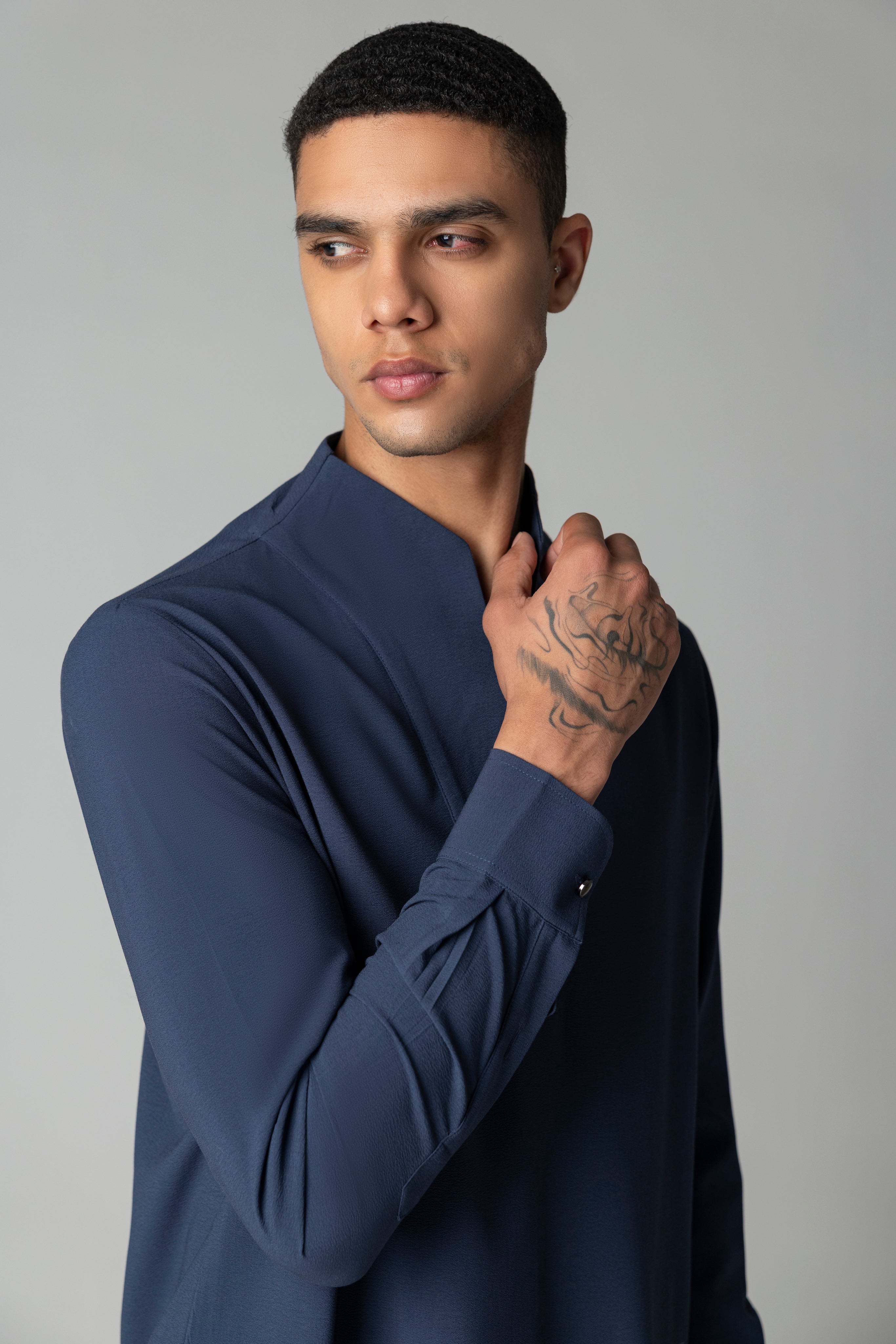Navy blue short crepe kurta with thread embroidery detailing on the waist, paired with a matching plazzo