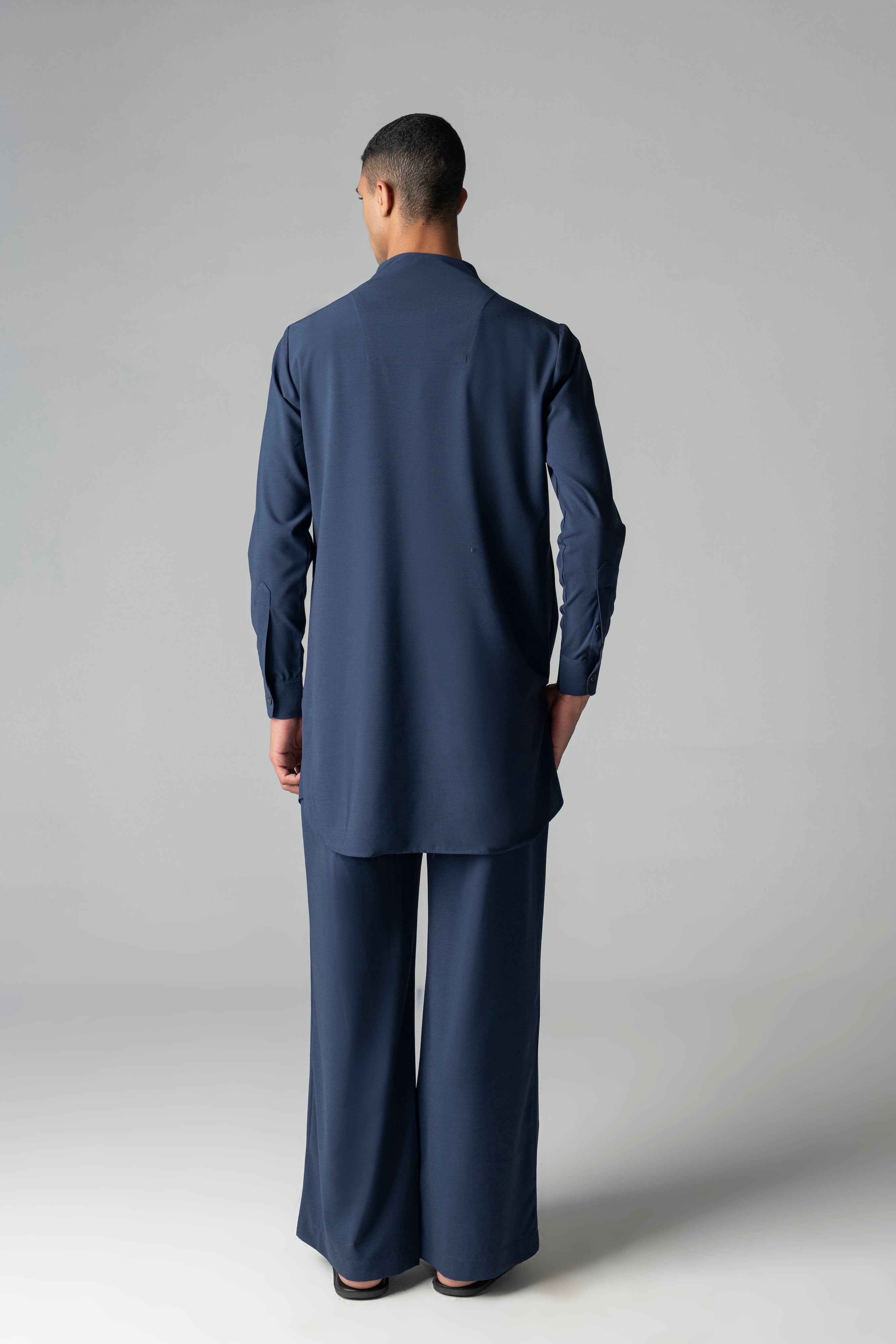Navy blue short crepe kurta with thread embroidery detailing on the waist, paired with a matching plazzo
