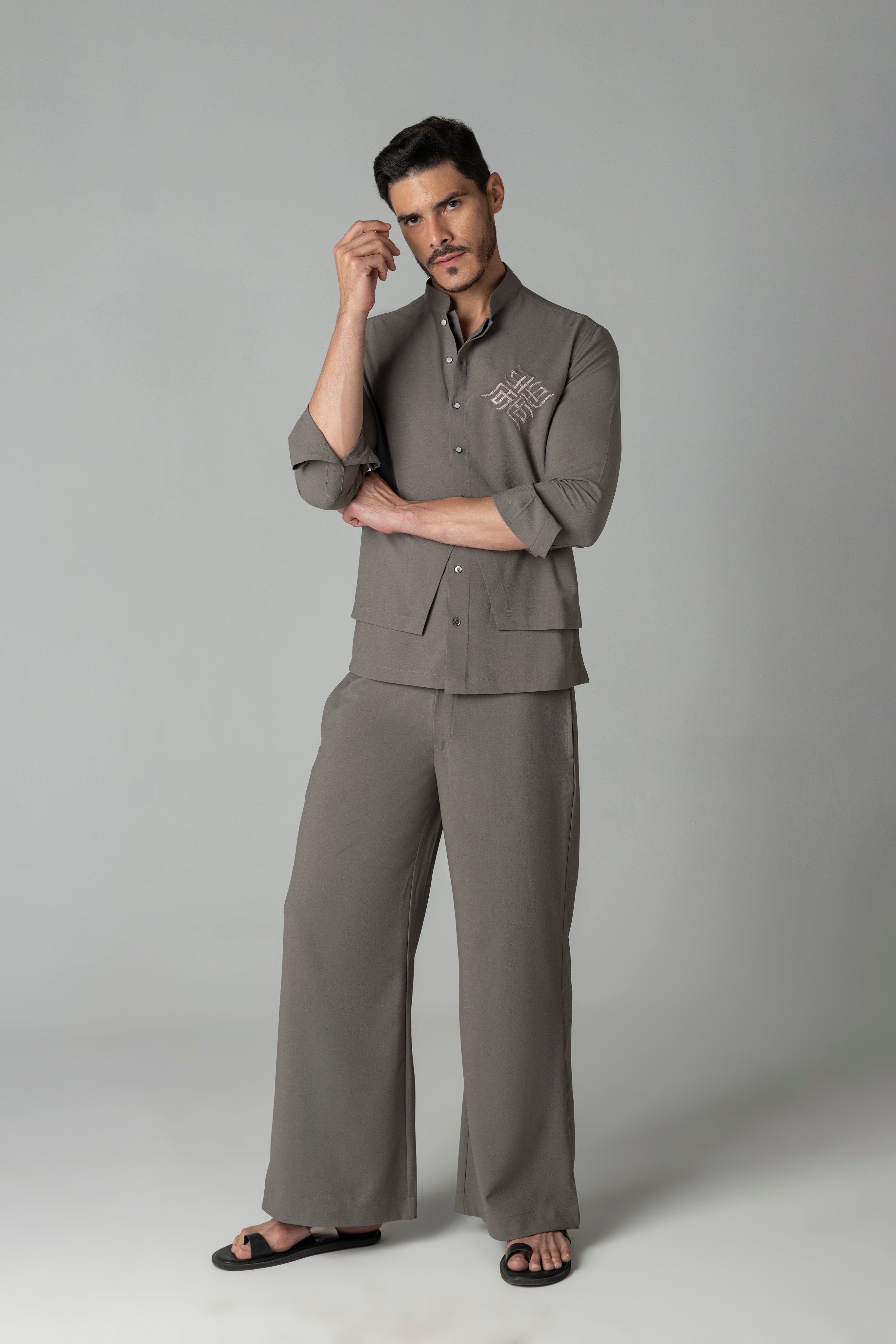 Mouse coloured shirt with asymmetrical cuts & thread embroidery detailing on the chest, paired with a matching plazzo