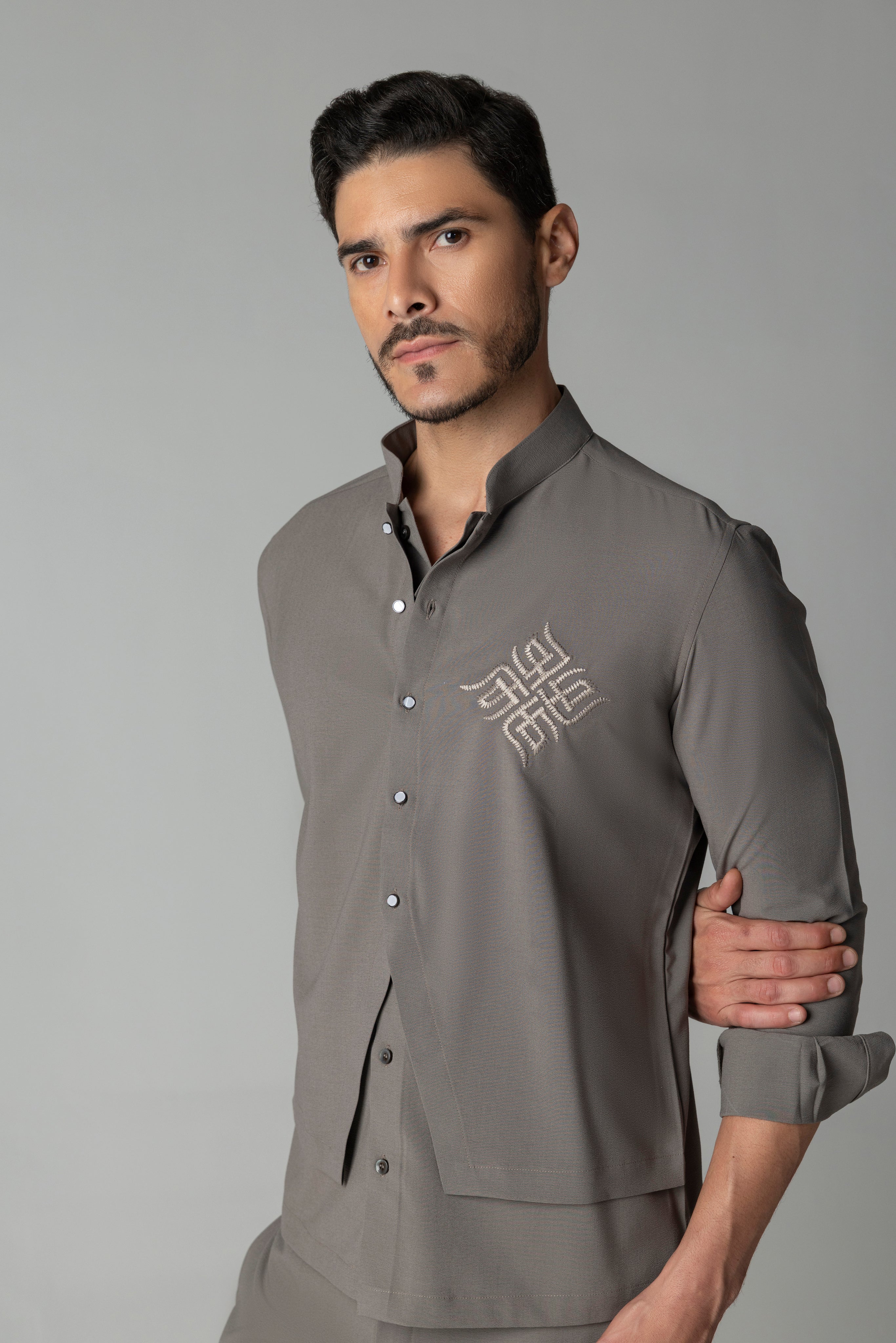 Mouse coloured shirt with asymmetrical cuts & thread embroidery detailing on the chest, paired with a matching plazzo