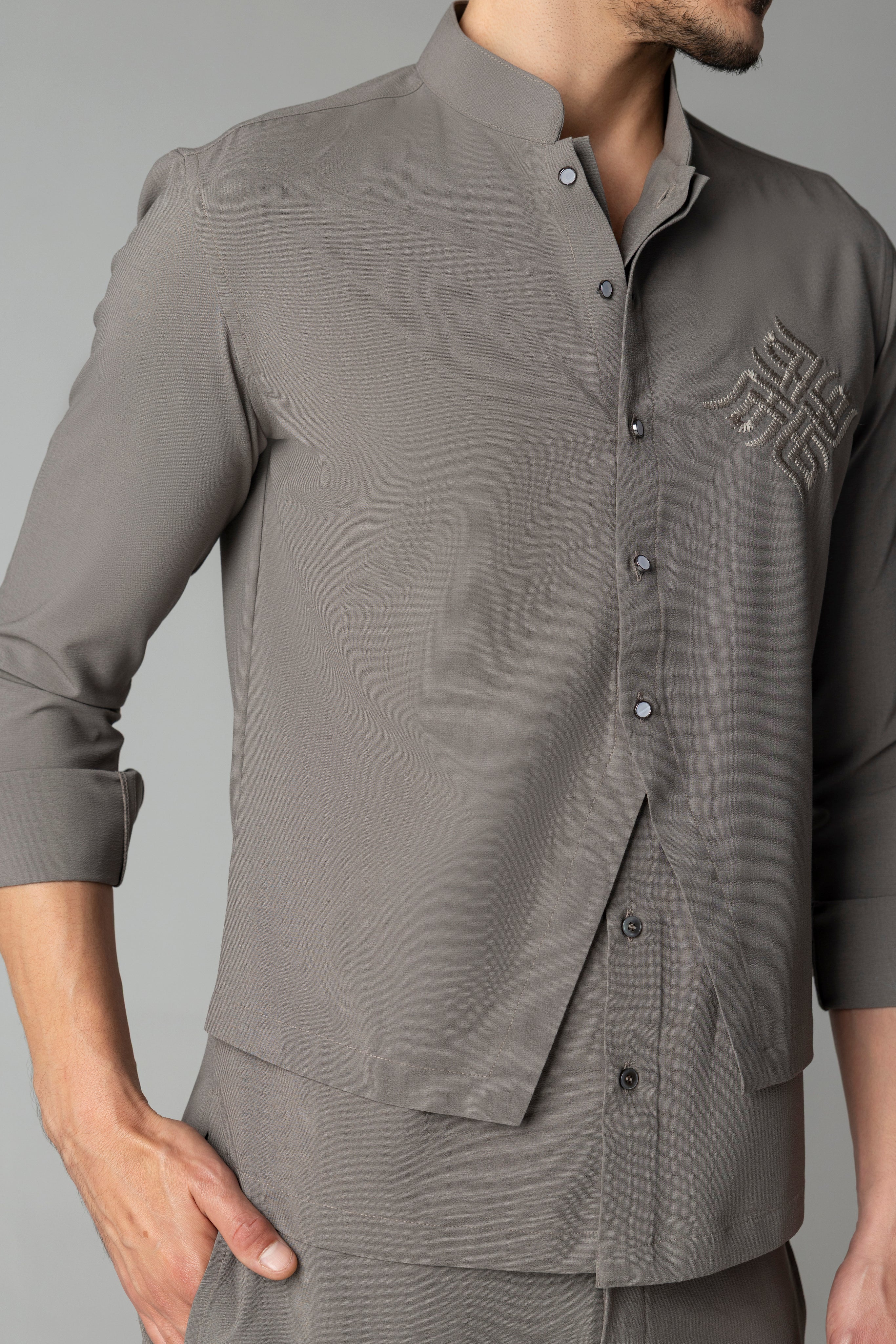 Mouse coloured shirt with asymmetrical cuts & thread embroidery detailing on the chest, paired with a matching plazzo