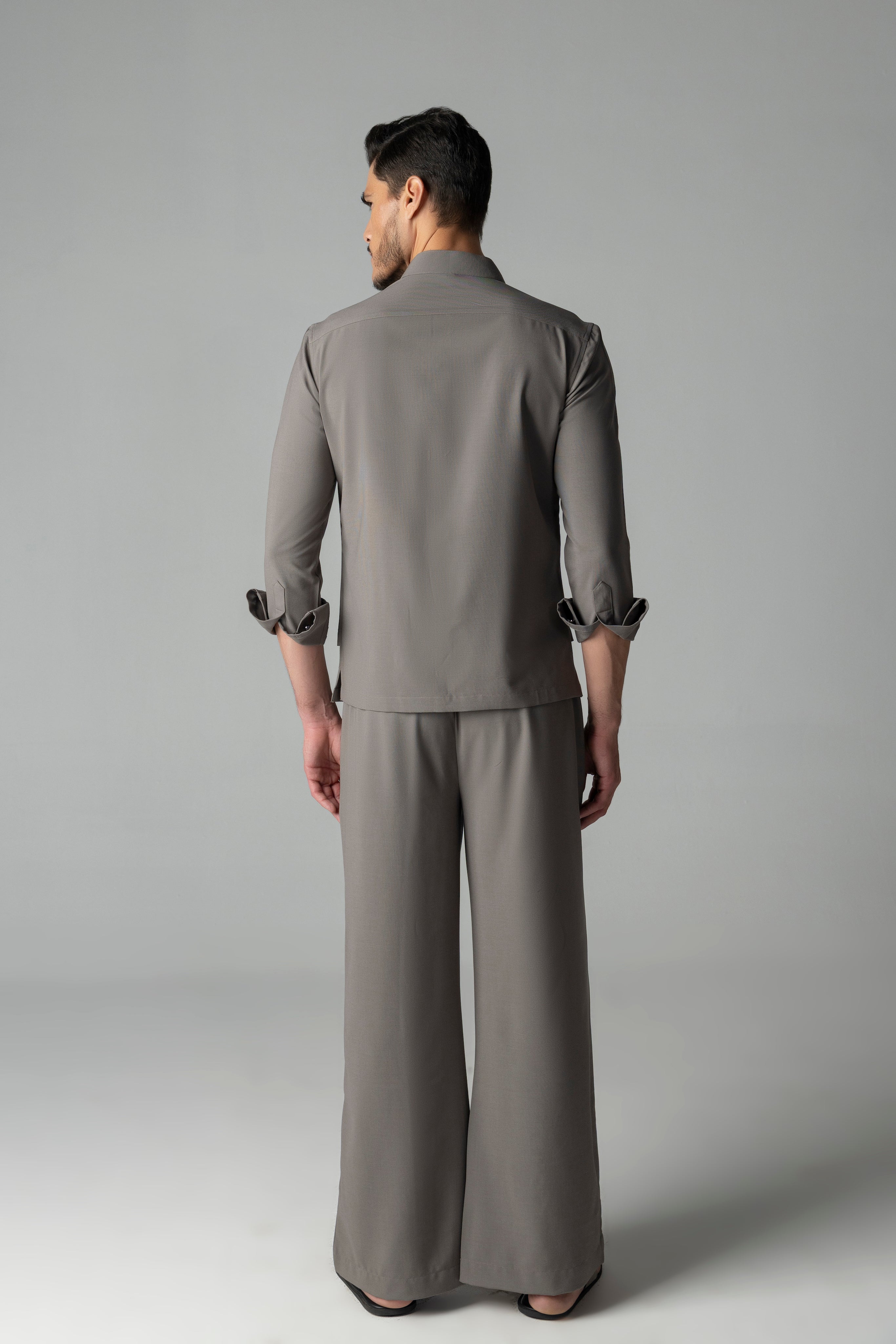 Mouse coloured shirt with asymmetrical cuts & thread embroidery detailing on the chest, paired with a matching plazzo