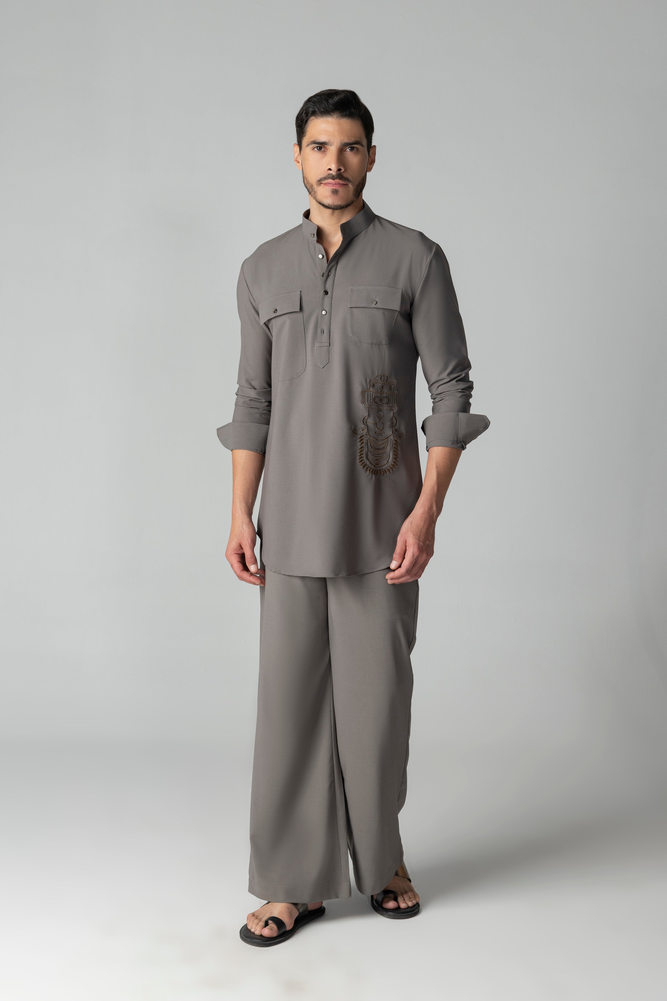 Mouse coloured short crepe kurta with thread embroidery on the waist & patch pocket detailing, paired with a matching plazzo