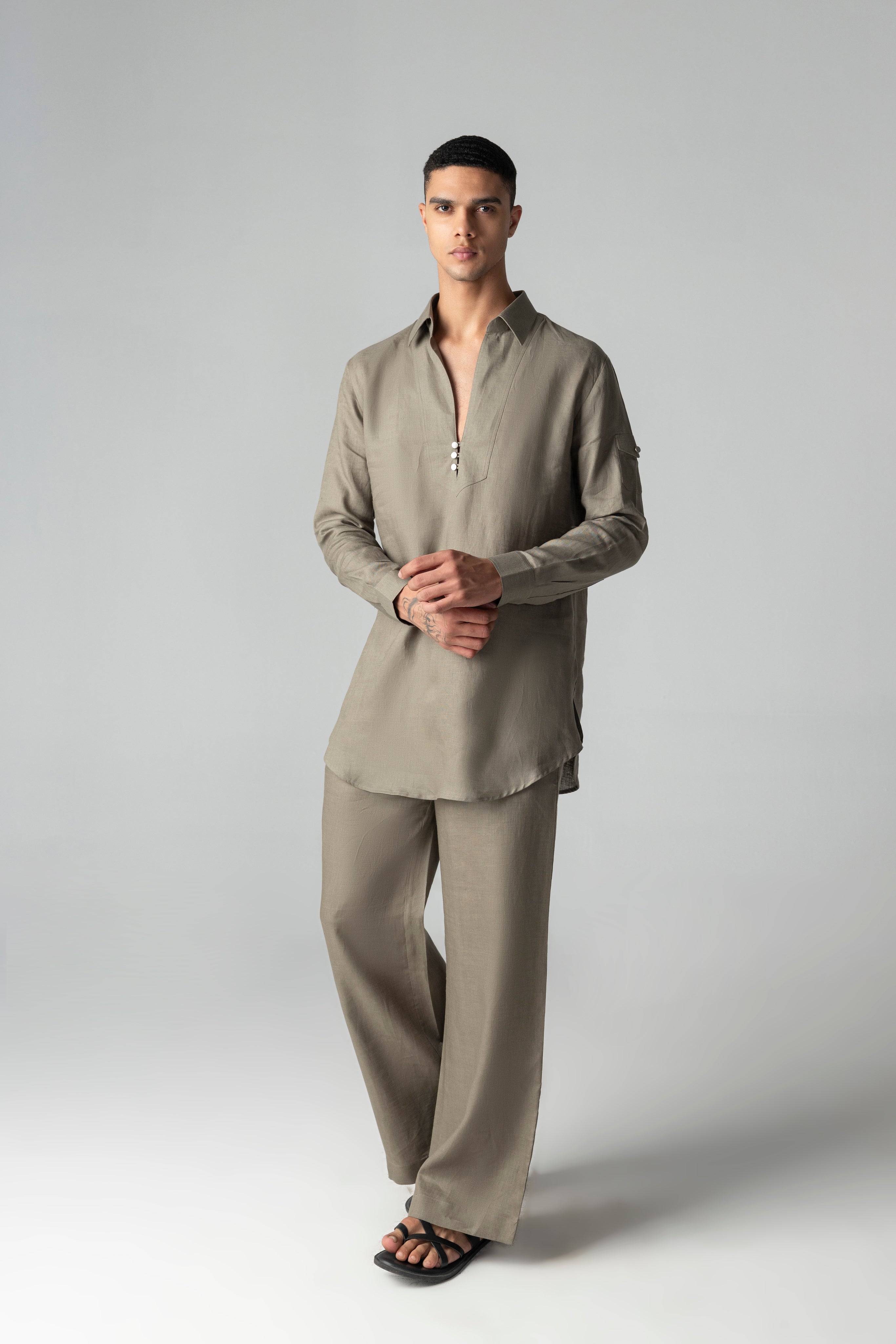 Olive green short linen kurta with button detailing, paired with a matching plazzo.
