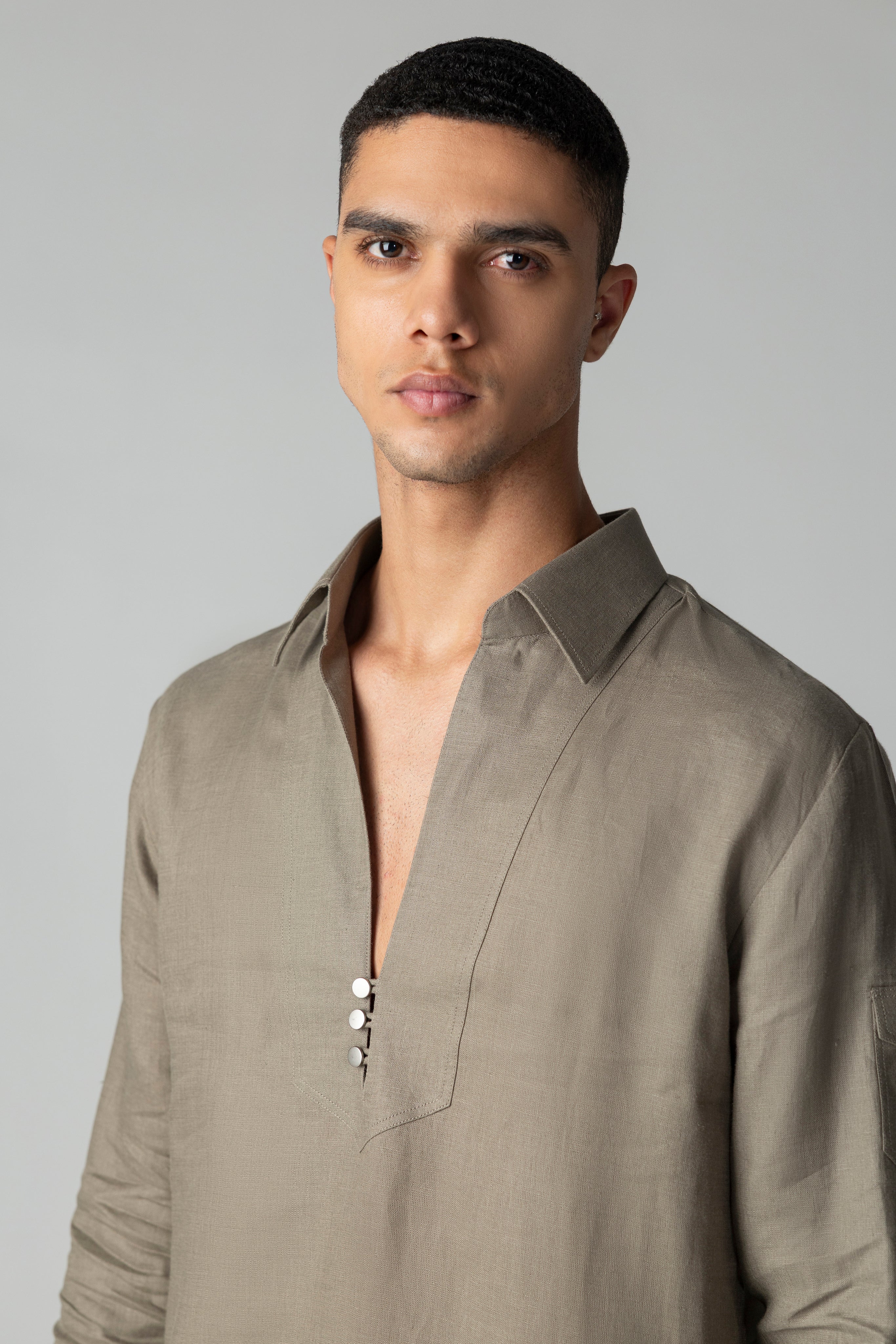 Olive green short linen kurta with button detailing, paired with a matching plazzo.