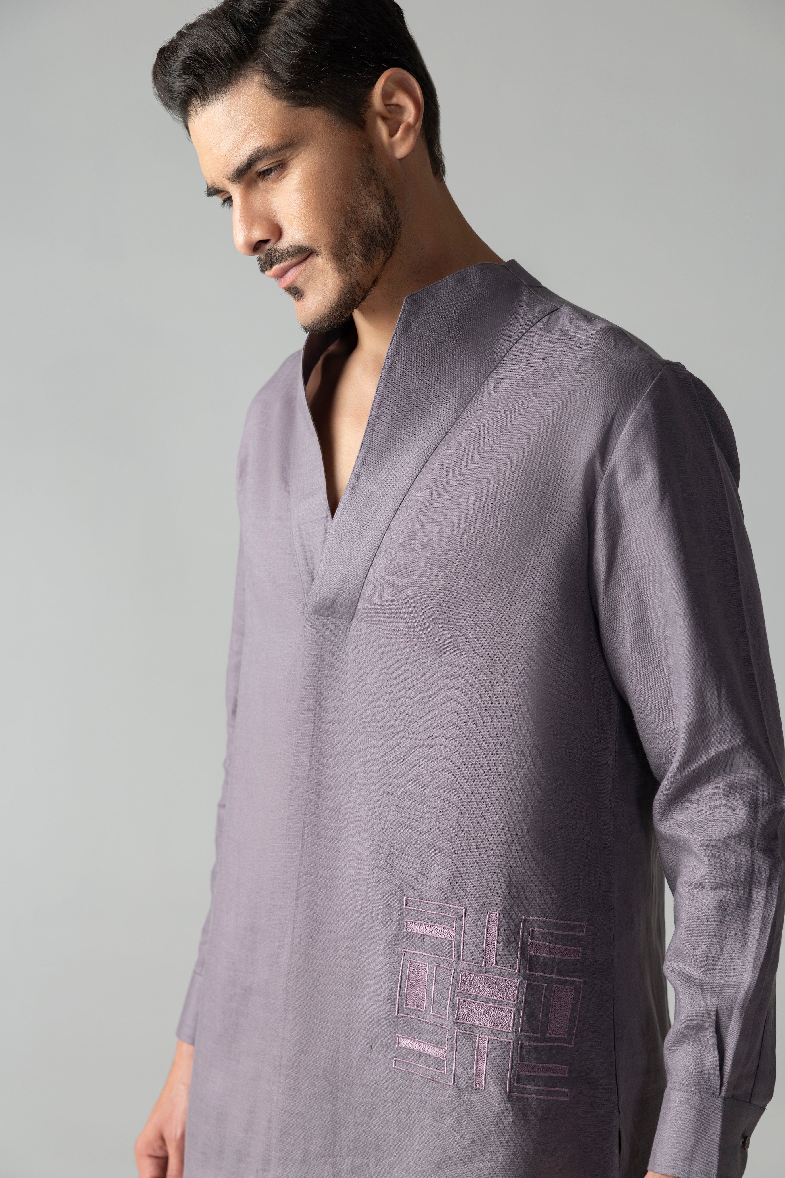 Mauve short linen kurta with thread embroidery detailing on the waist, paired with a matching plazzo