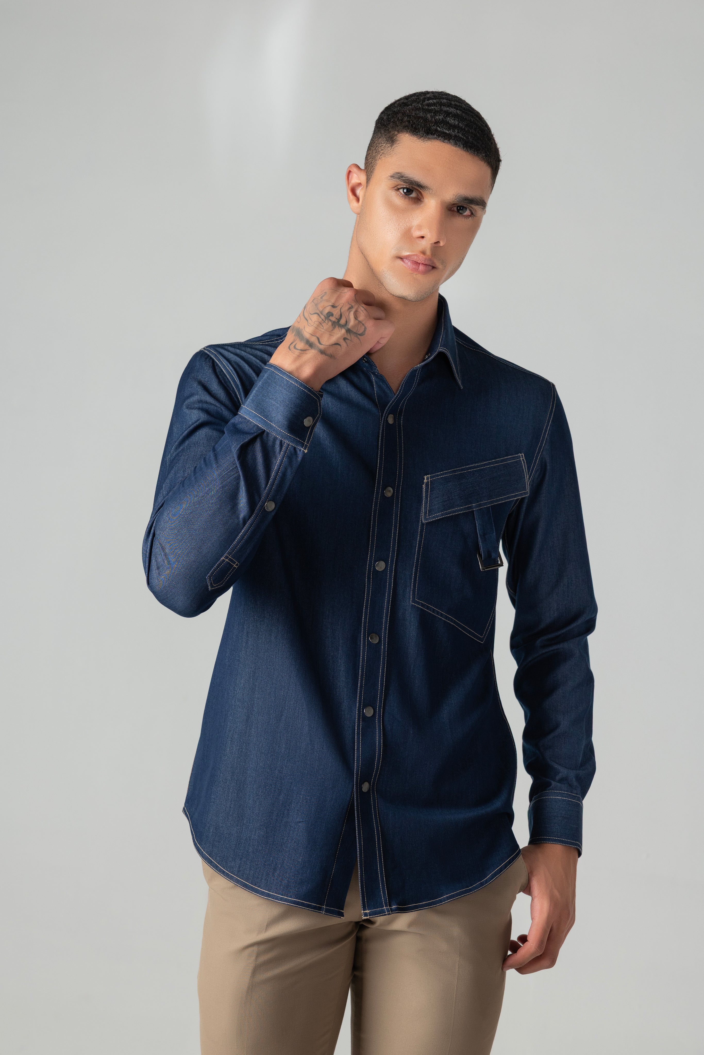 Dark denim shirt with patch pocket & buckle detailing.