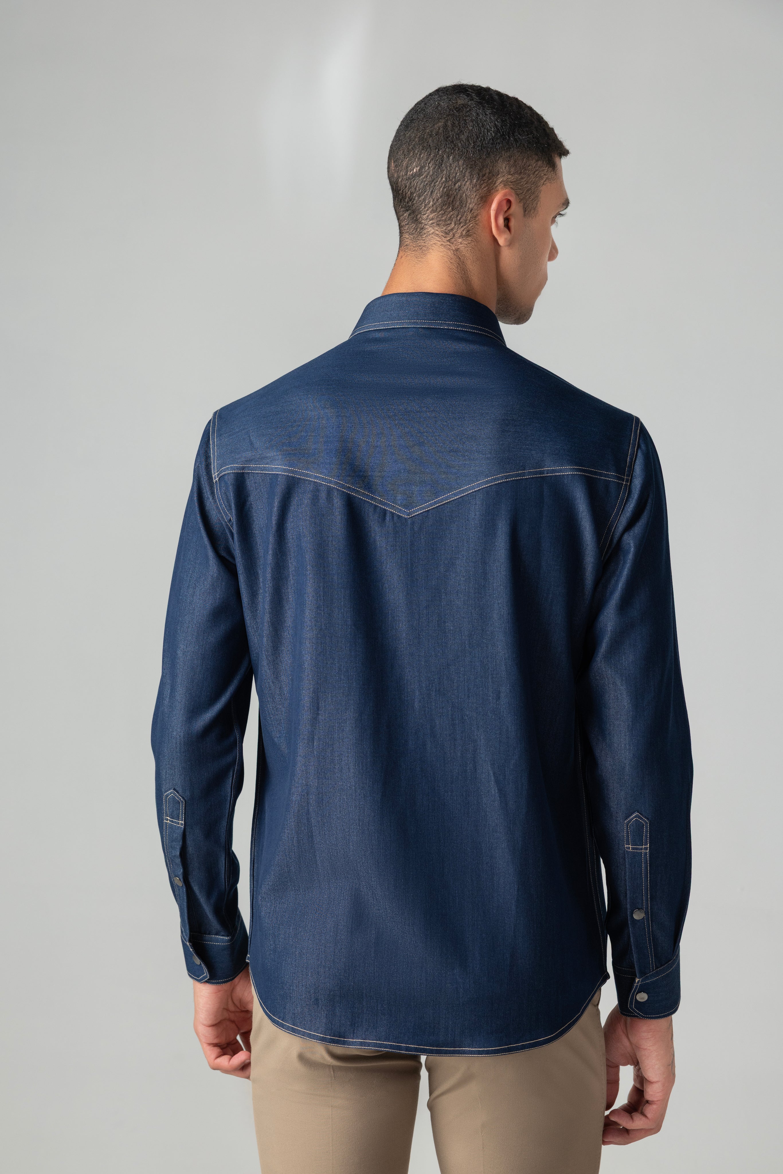 Dark denim shirt with patch pocket & buckle detailing.