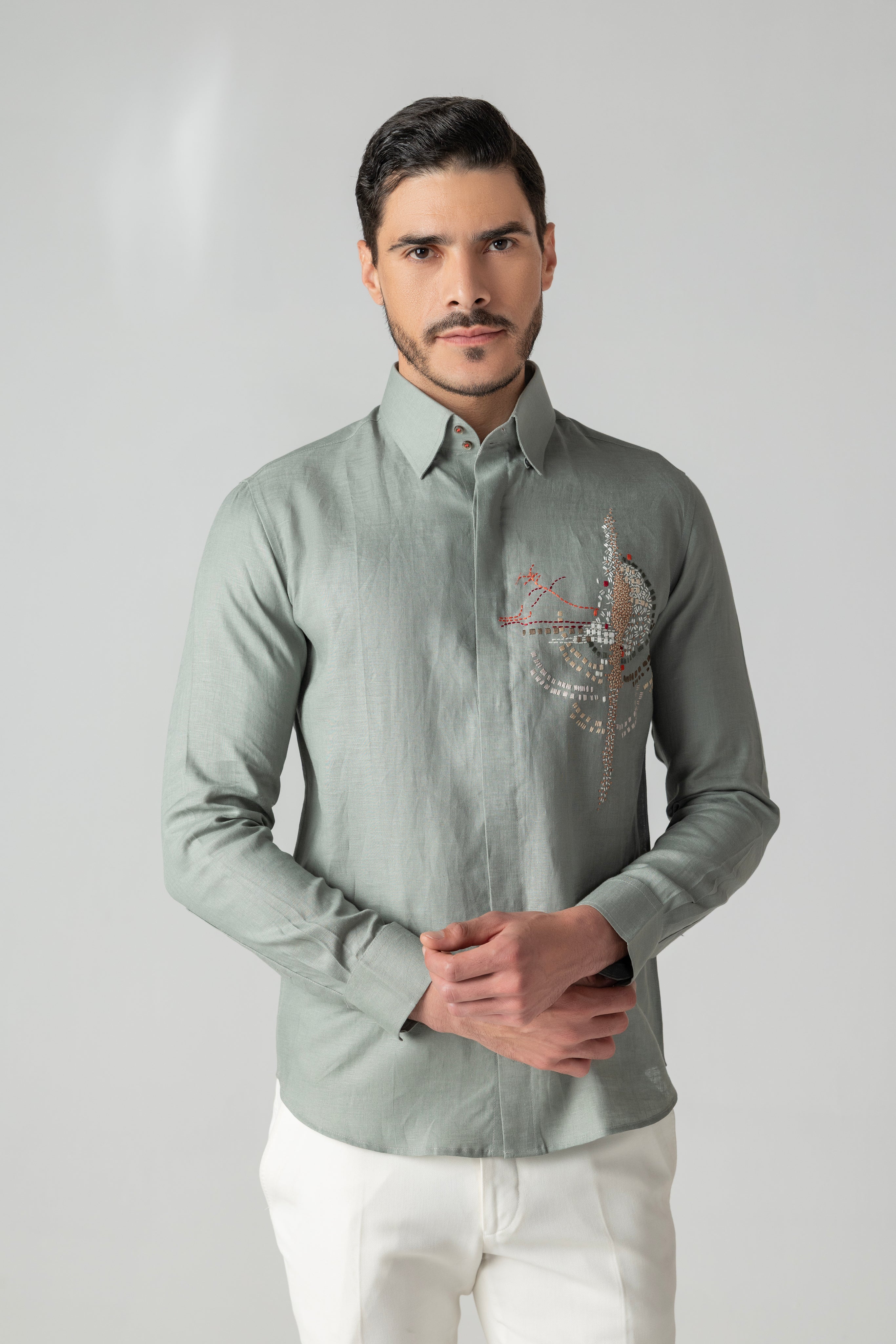 Sage green linen shirt with multi-coloured hand-embroidered motif