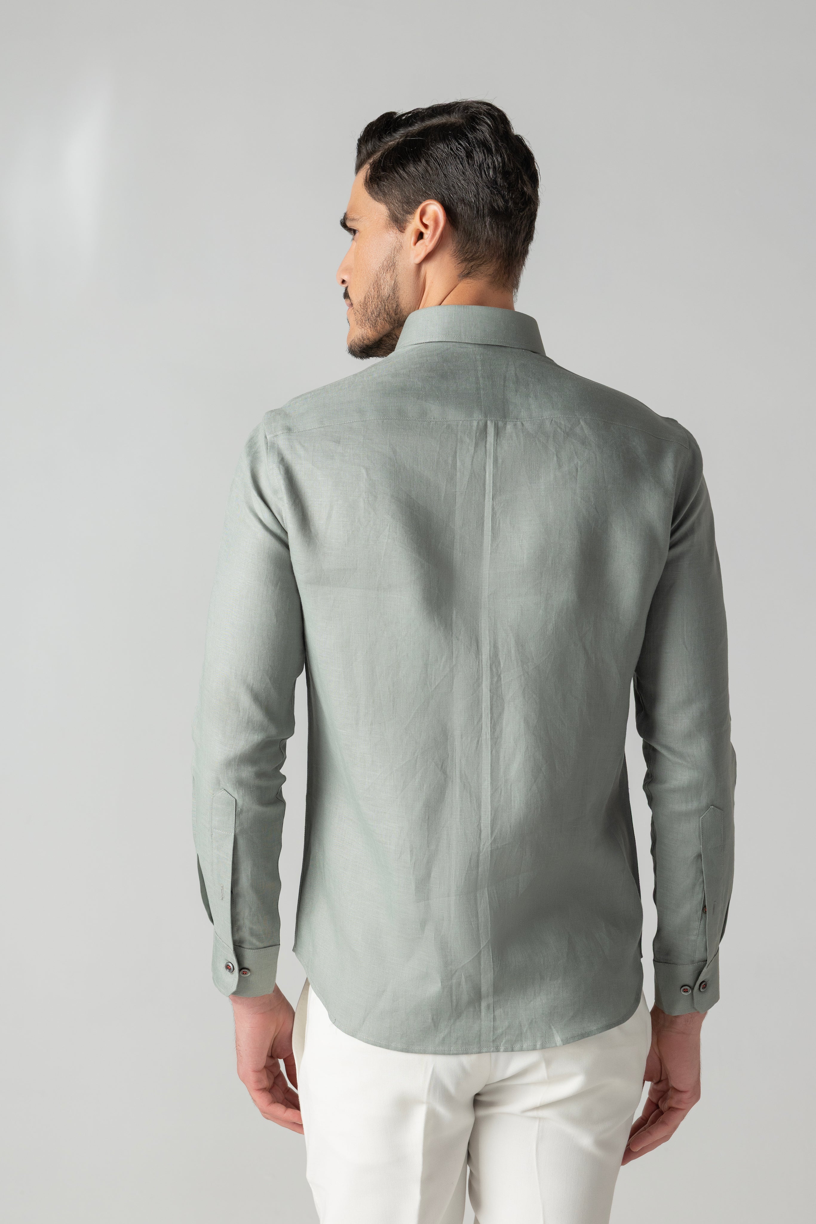 Sage green linen shirt with multi-coloured hand-embroidered motif