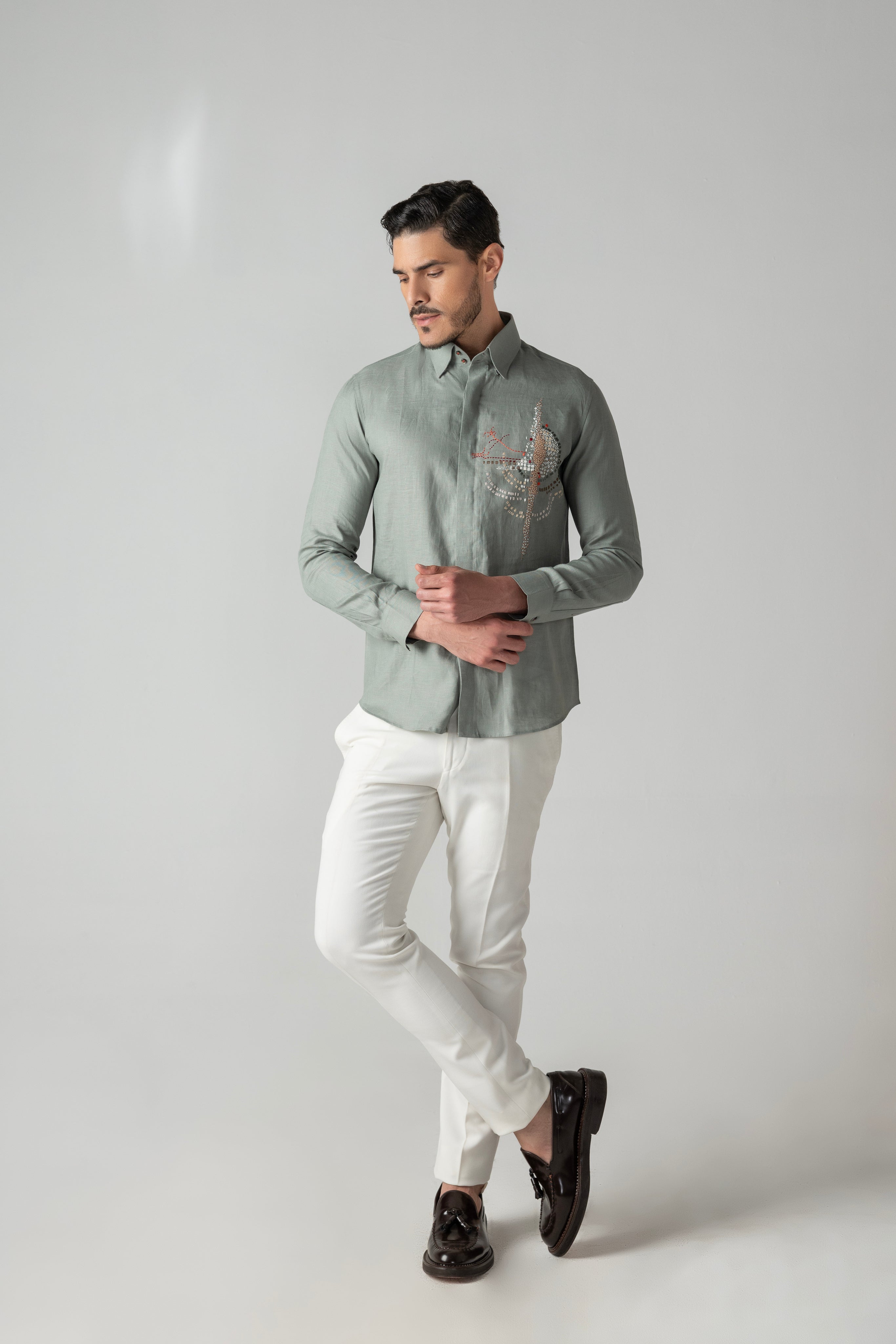 Sage green linen shirt with multi-coloured hand-embroidered motif