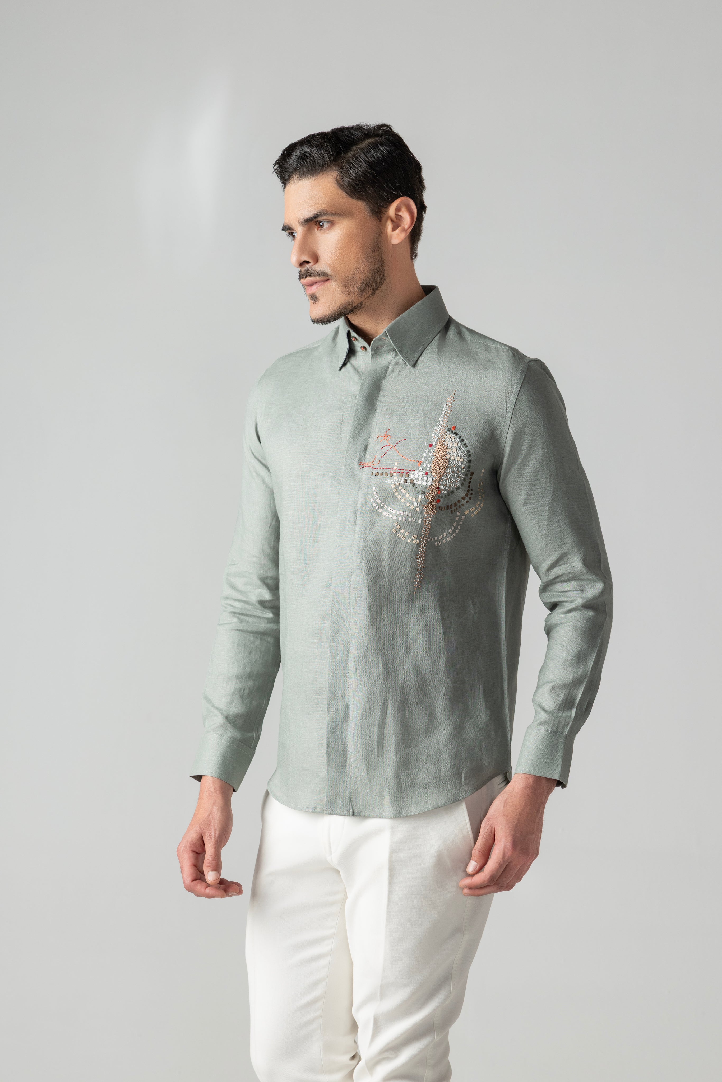 Sage green linen shirt with multi-coloured hand-embroidered motif
