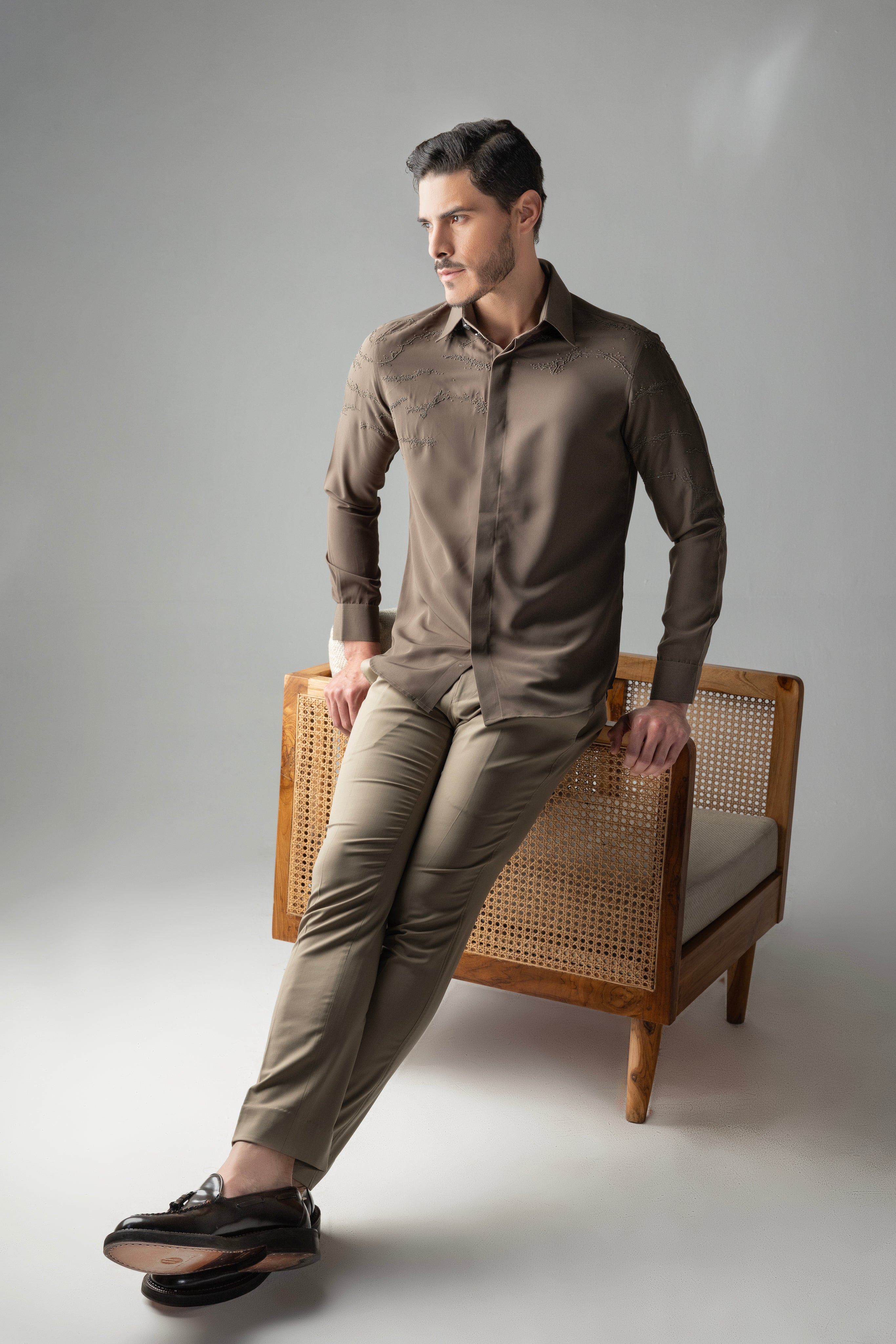 Olive green shirt with abstract monotone hand-embroidered detailing.