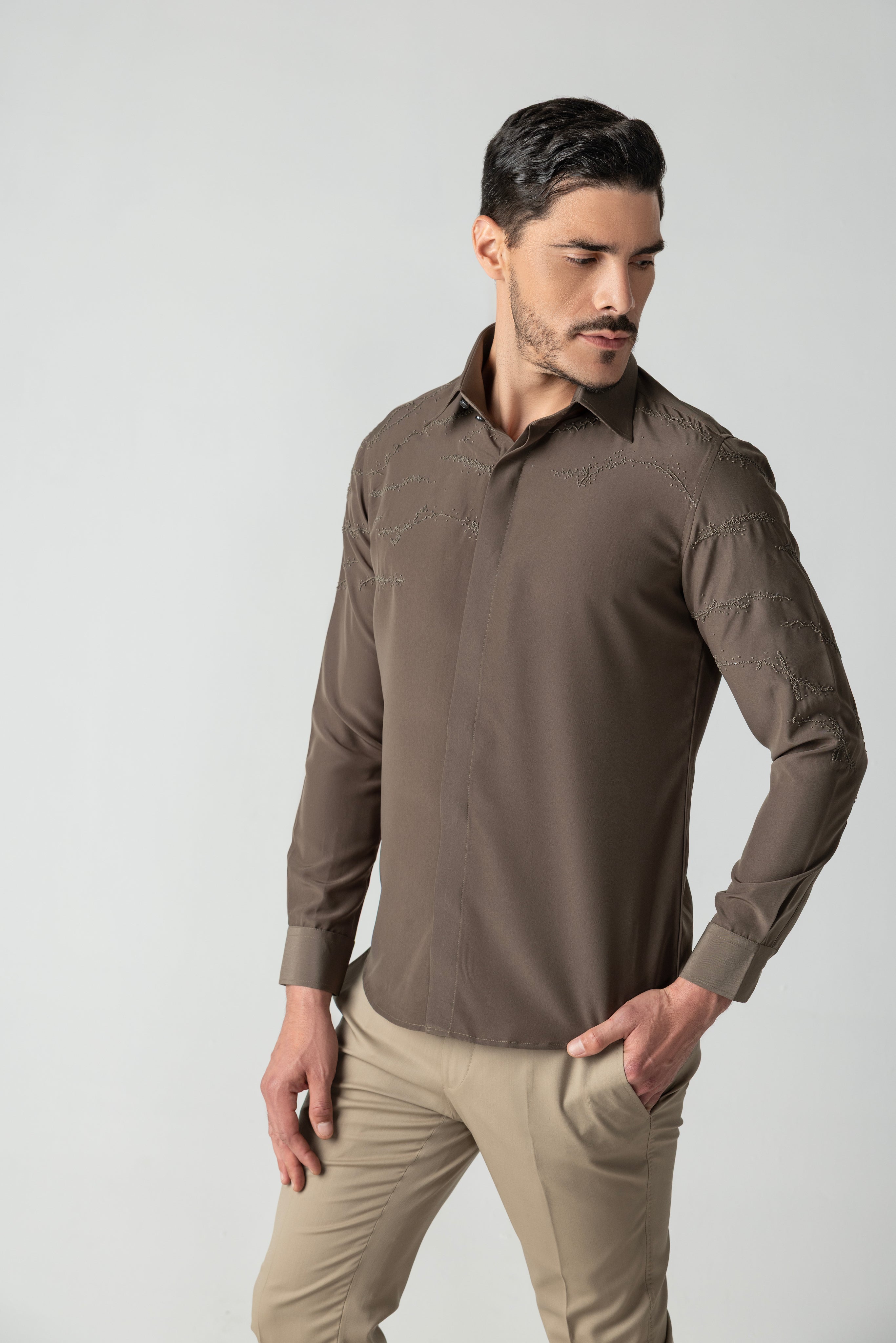 Olive green shirt with abstract monotone hand-embroidered detailing.