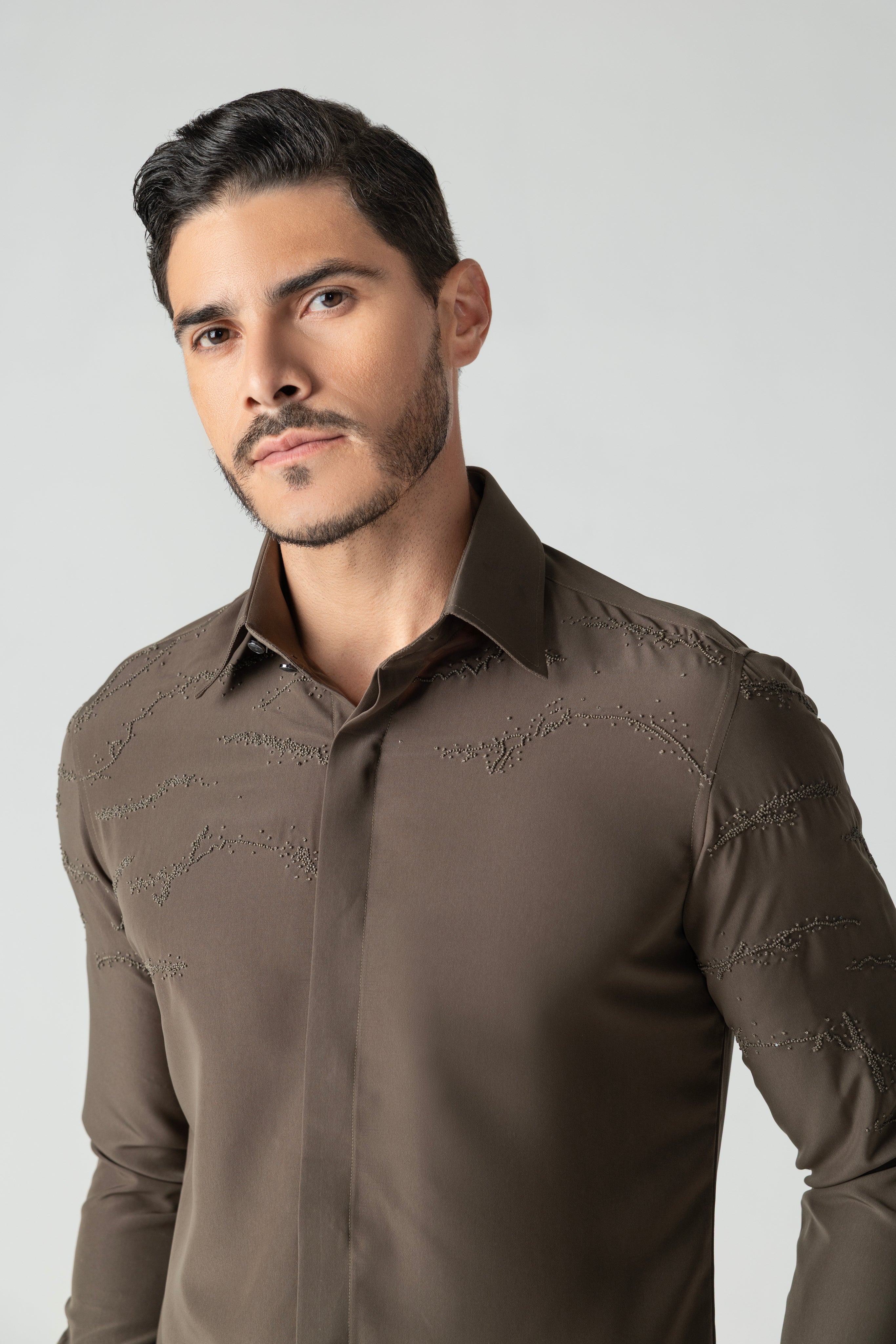 Olive green shirt with abstract monotone hand-embroidered detailing.