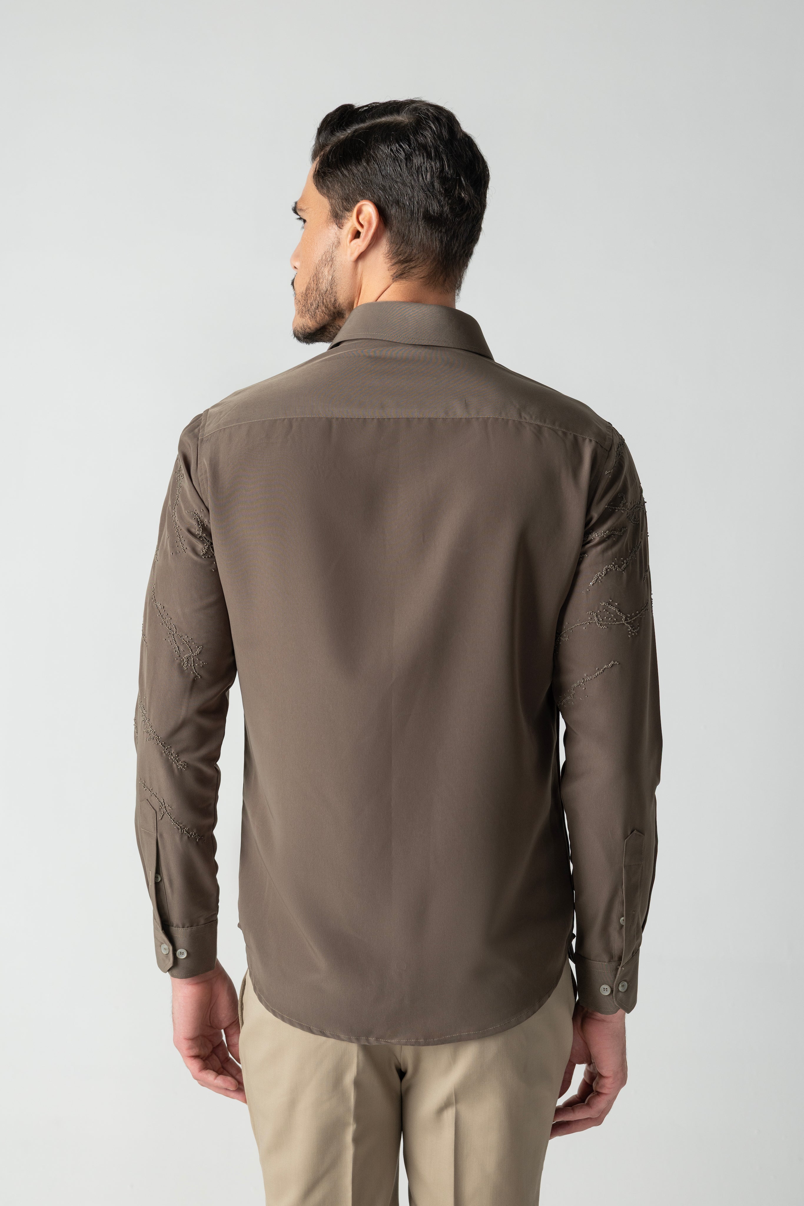 Olive green shirt with abstract monotone hand-embroidered detailing.