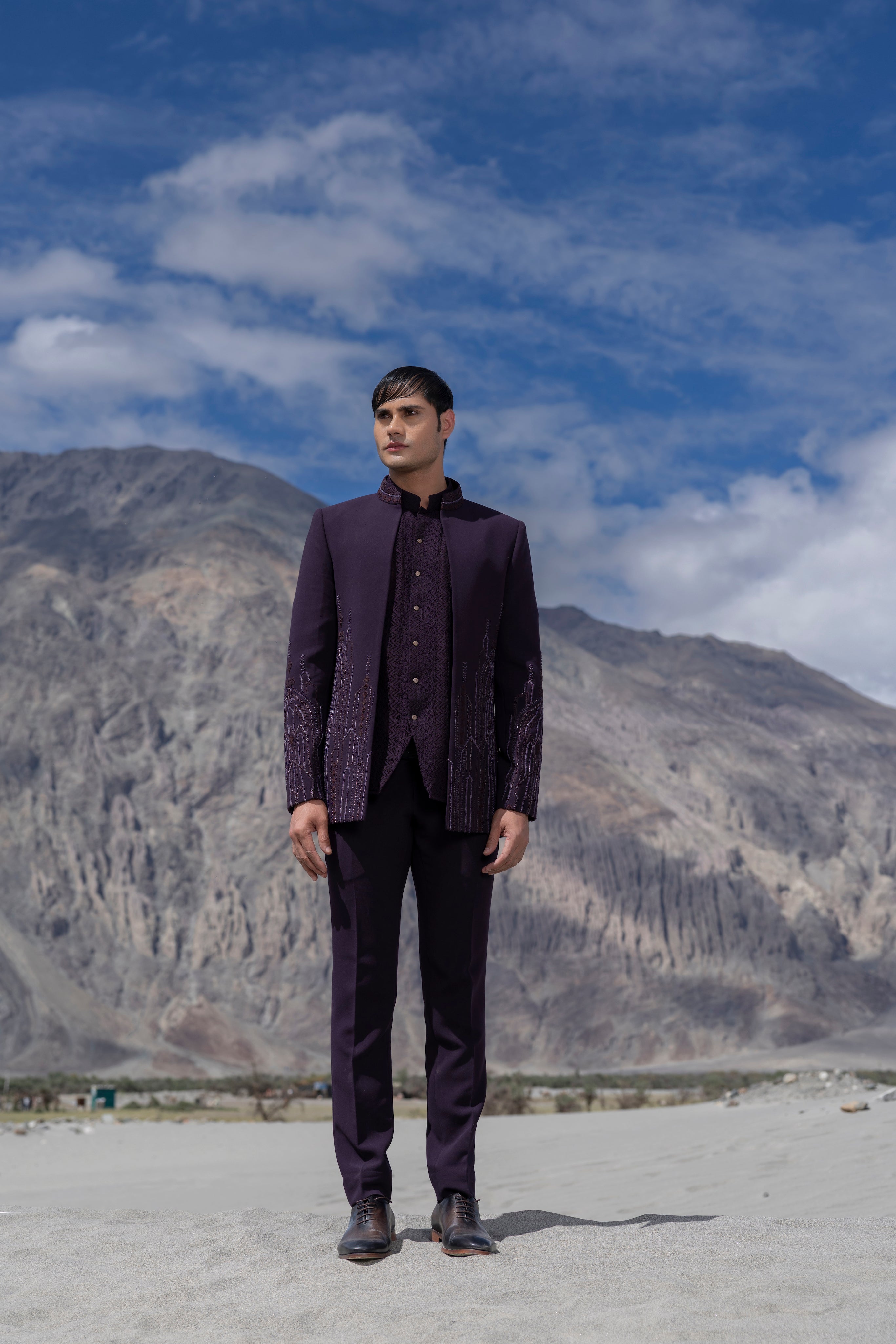 Purple front open short indowestern jacket with monotone hand-embroidery paired with a crochet waistcoat and a pant.