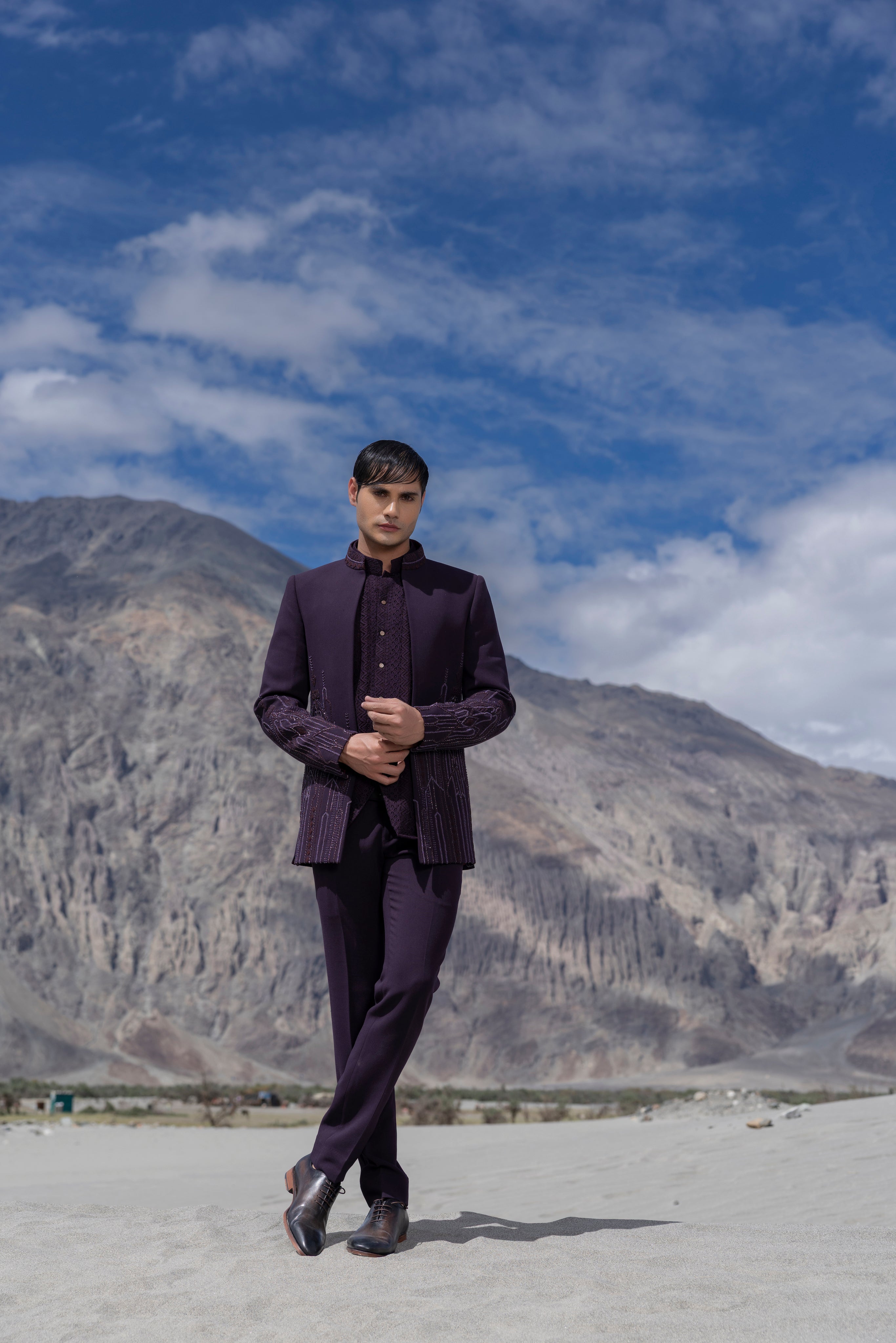 Purple front open short indowestern jacket with monotone hand-embroidery paired with a crochet waistcoat and a pant.