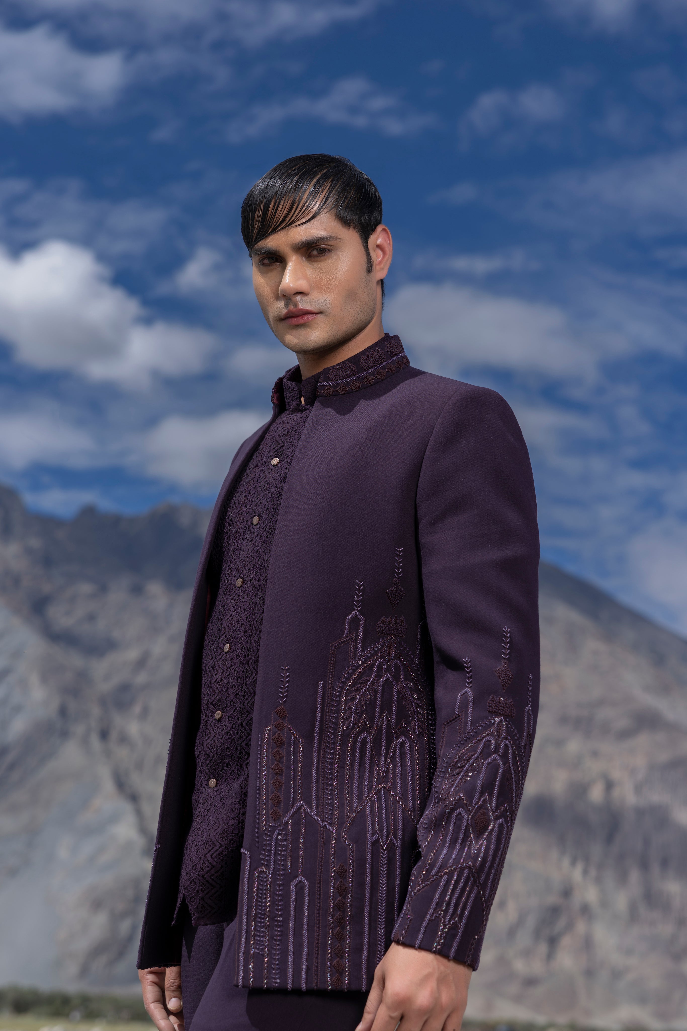 Purple front open short indowestern jacket with monotone hand-embroidery paired with a crochet waistcoat and a pant.