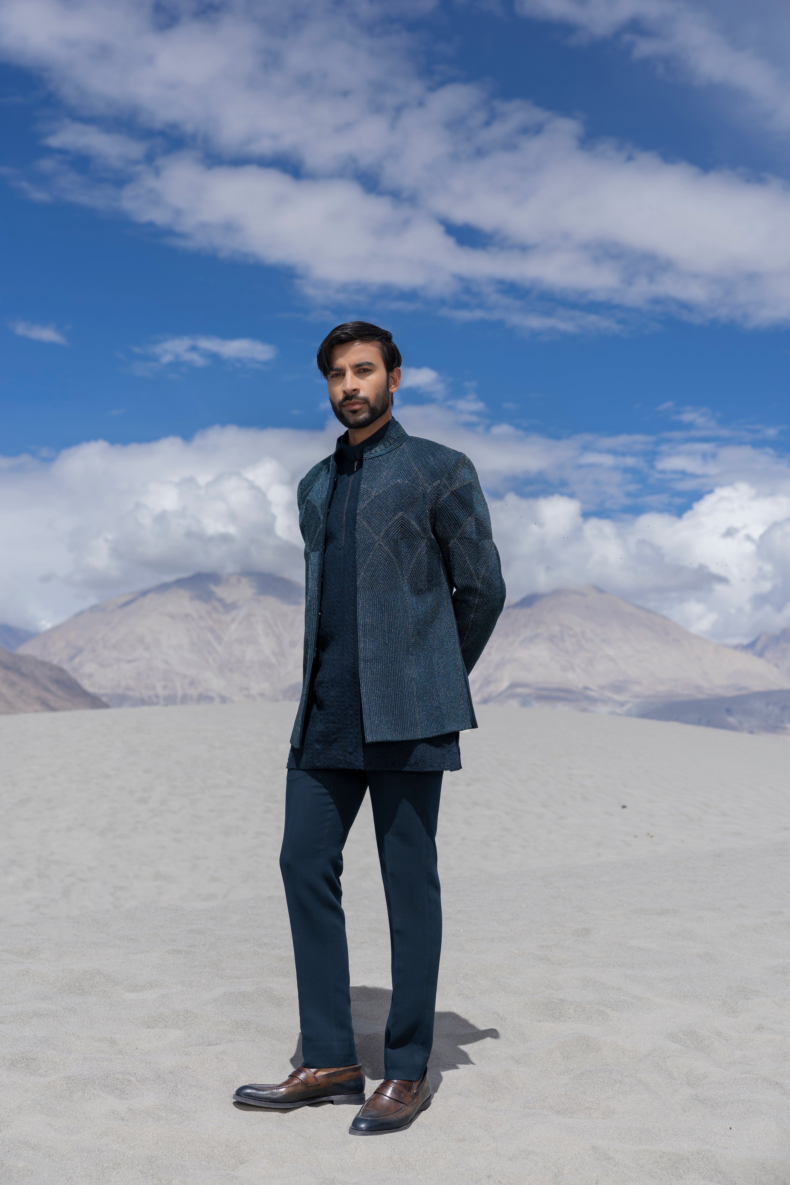 Turquoise front open indowestern jacket with monotone  hand-embroidery paired with a crochet kurta with zipper detailing and a pant.
