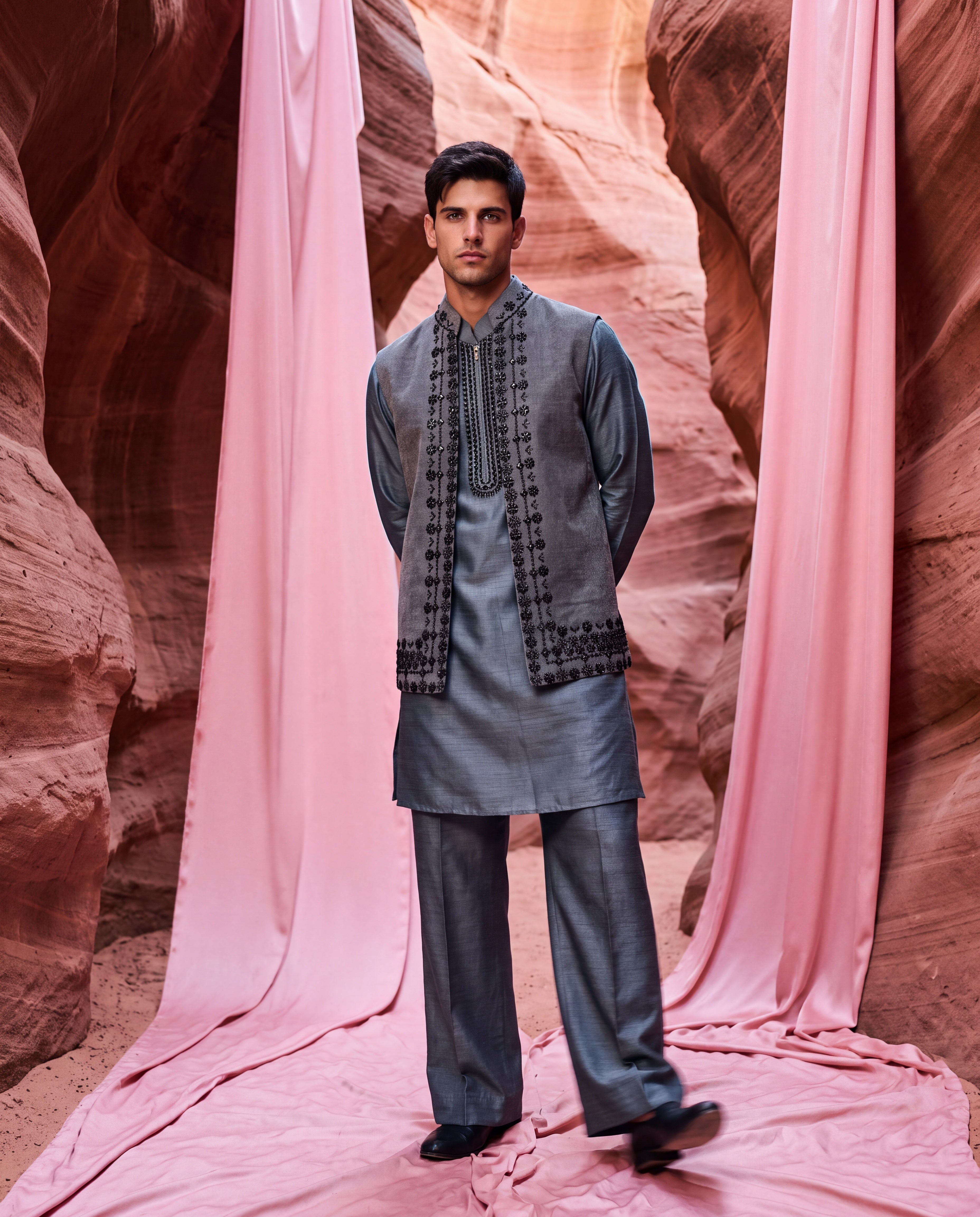 Grey textured velvet waistcoat with metallic hand embroidery detailing, paired with an embroidered silk kurta and matching aligadhi pants.