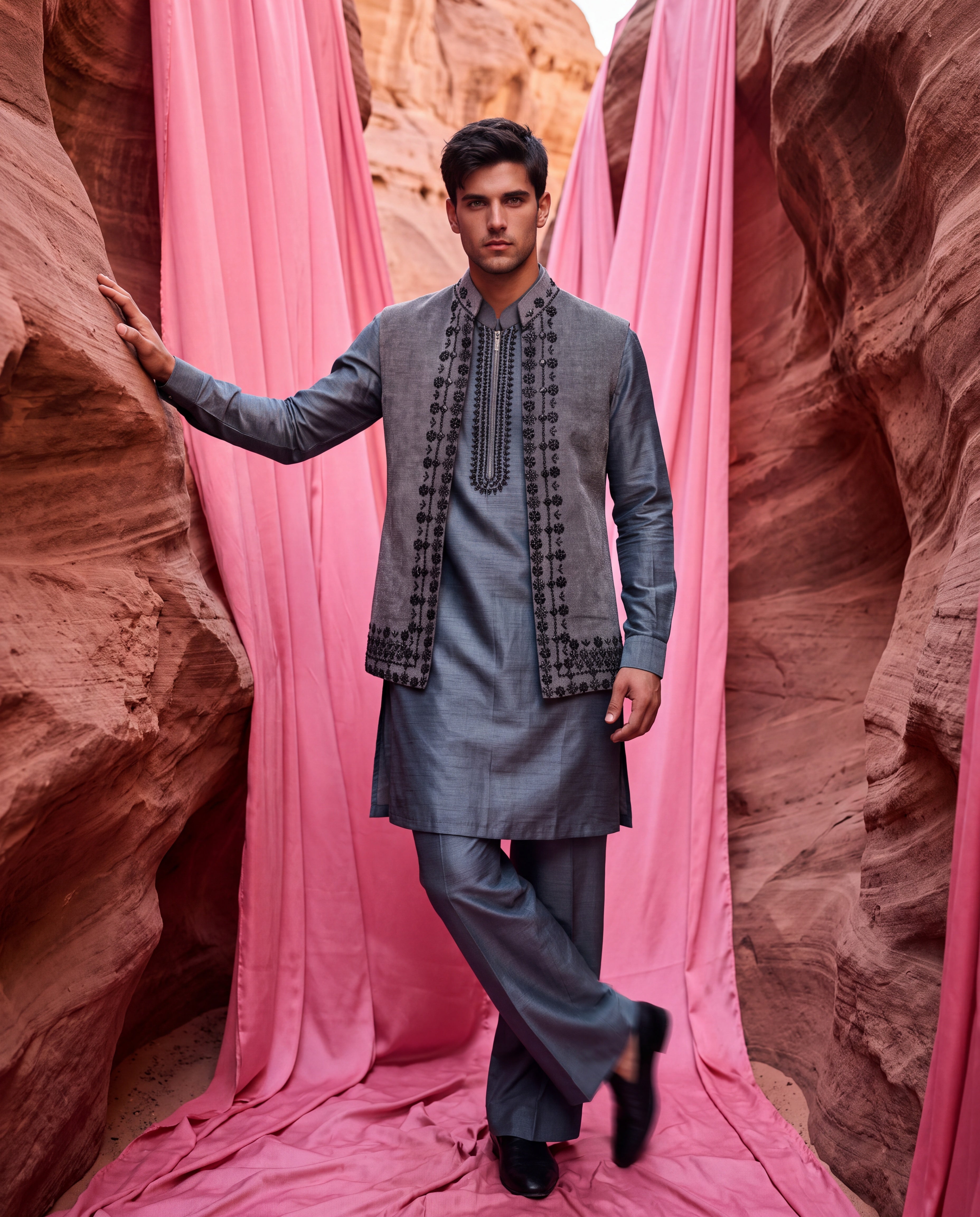 Grey textured velvet waistcoat with metallic hand embroidery detailing, paired with an embroidered silk kurta and matching aligadhi pants.