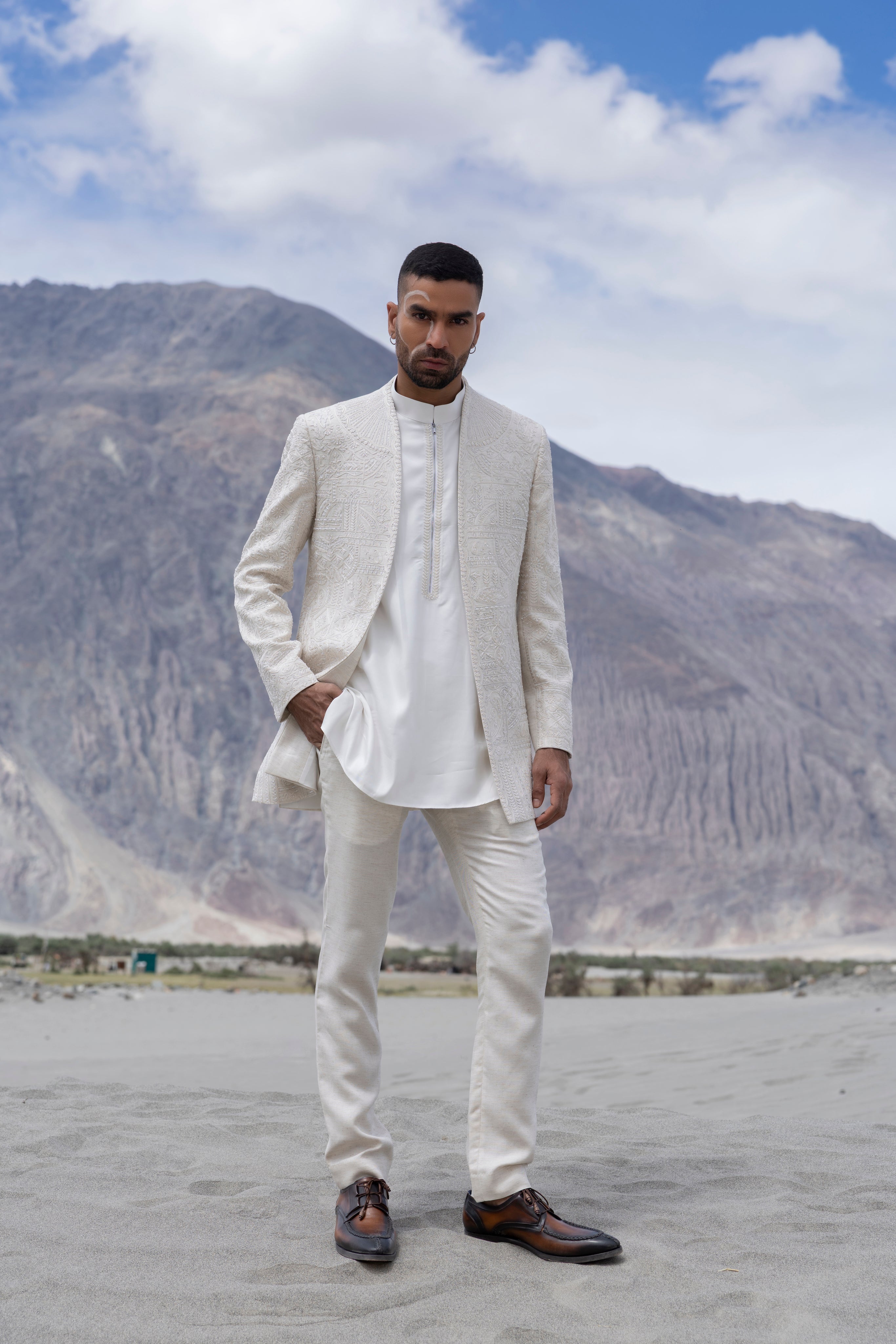 Beige poly linen, front open short indowestern jacket with monotone hand-embroidery paired with an embroidered kurta and a poly linen pant.