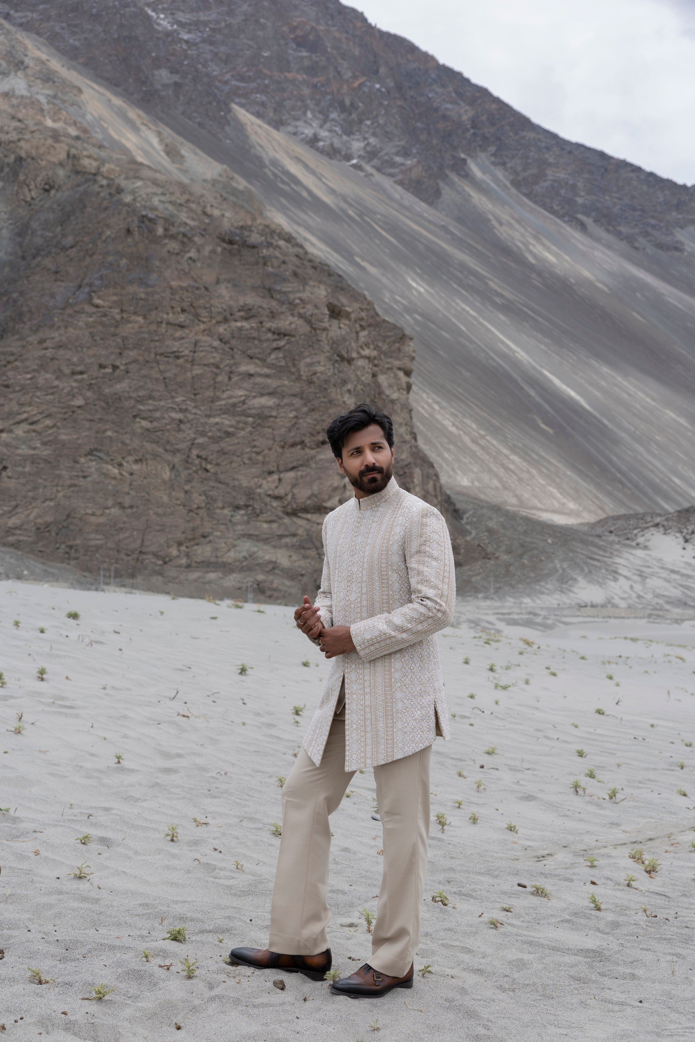 Khakhi tissue silk long  indowestern jacket with ivory hand-embroidery paired with a poly knit pant.