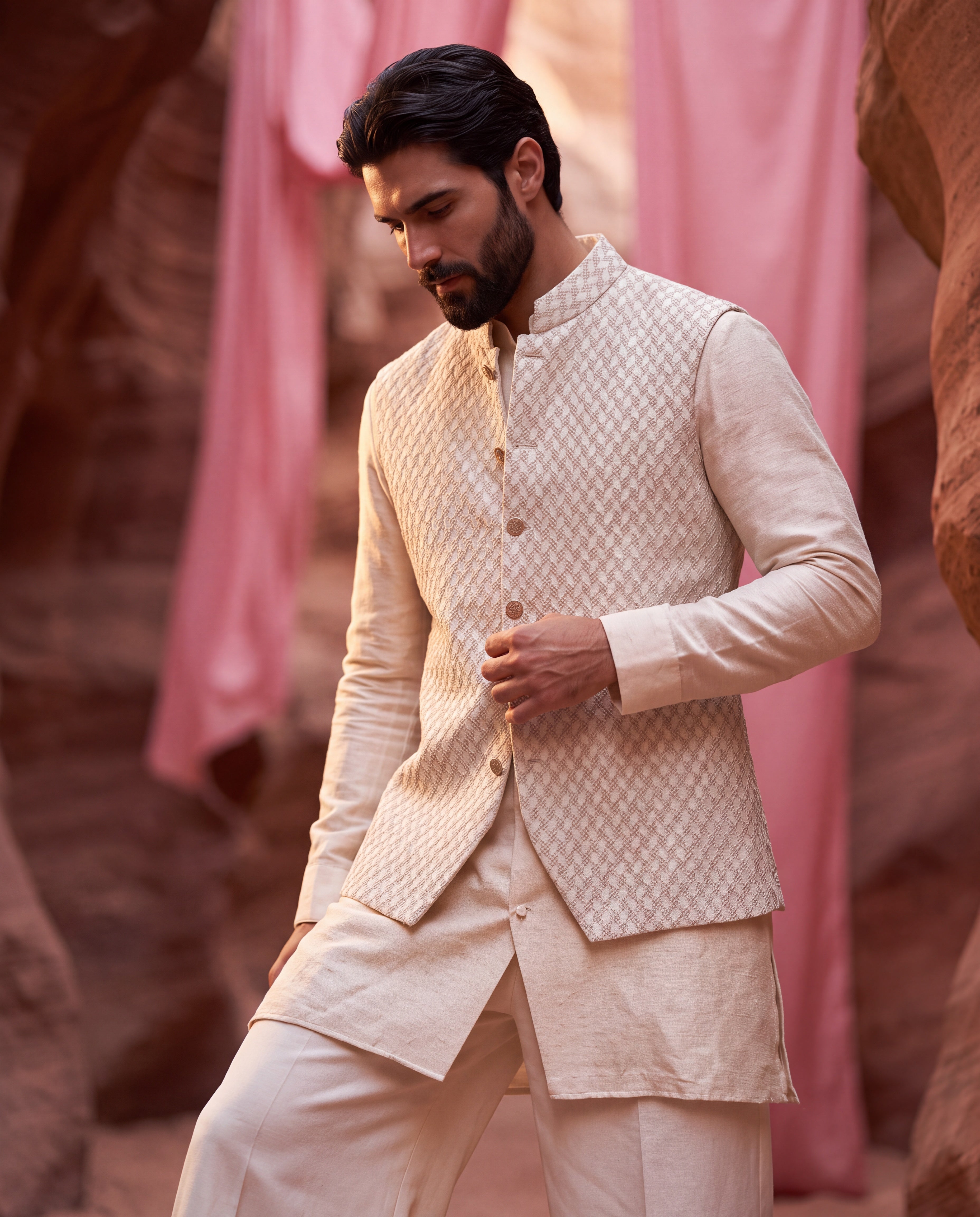 Light beige Banarasi Silk waistcoat with French knots hand embroidery detailing, paired with a silk kurta and matching aligadhi pants.