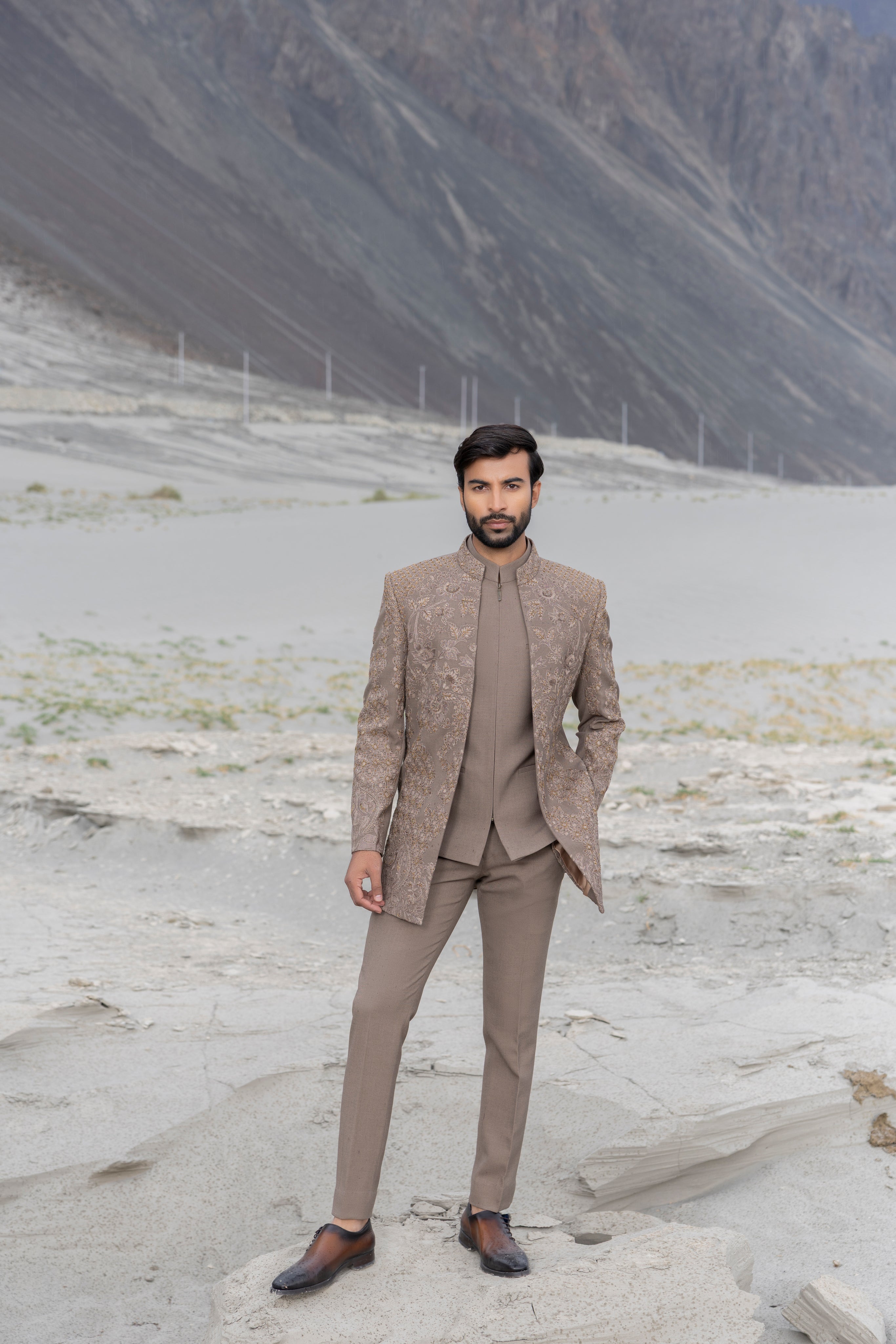 khakhi open indowestern jacket with monotone hand-embroidery paired with a front zippered waistcoat and matching pants.