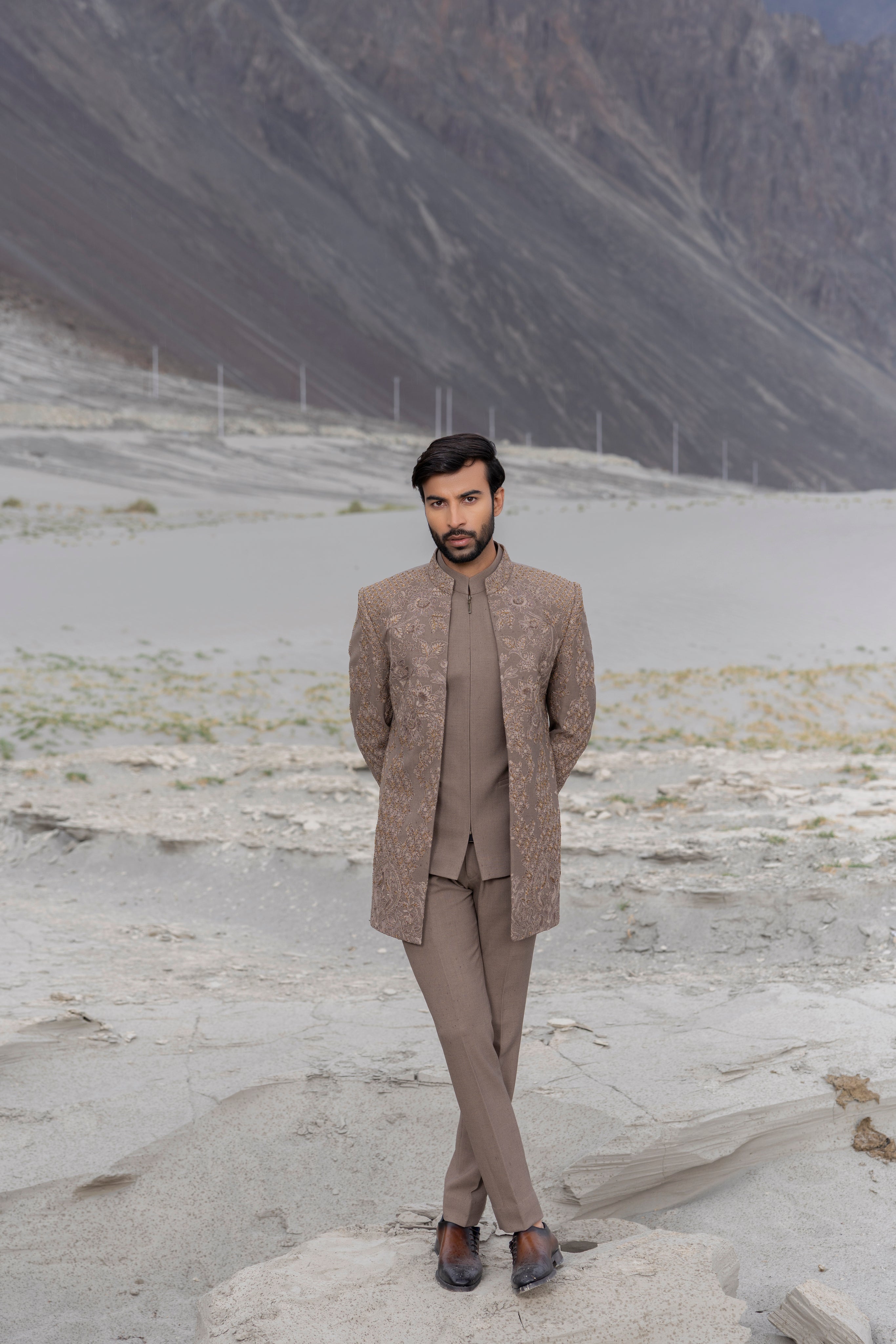 khakhi open indowestern jacket with monotone hand-embroidery paired with a front zippered waistcoat and matching pants.