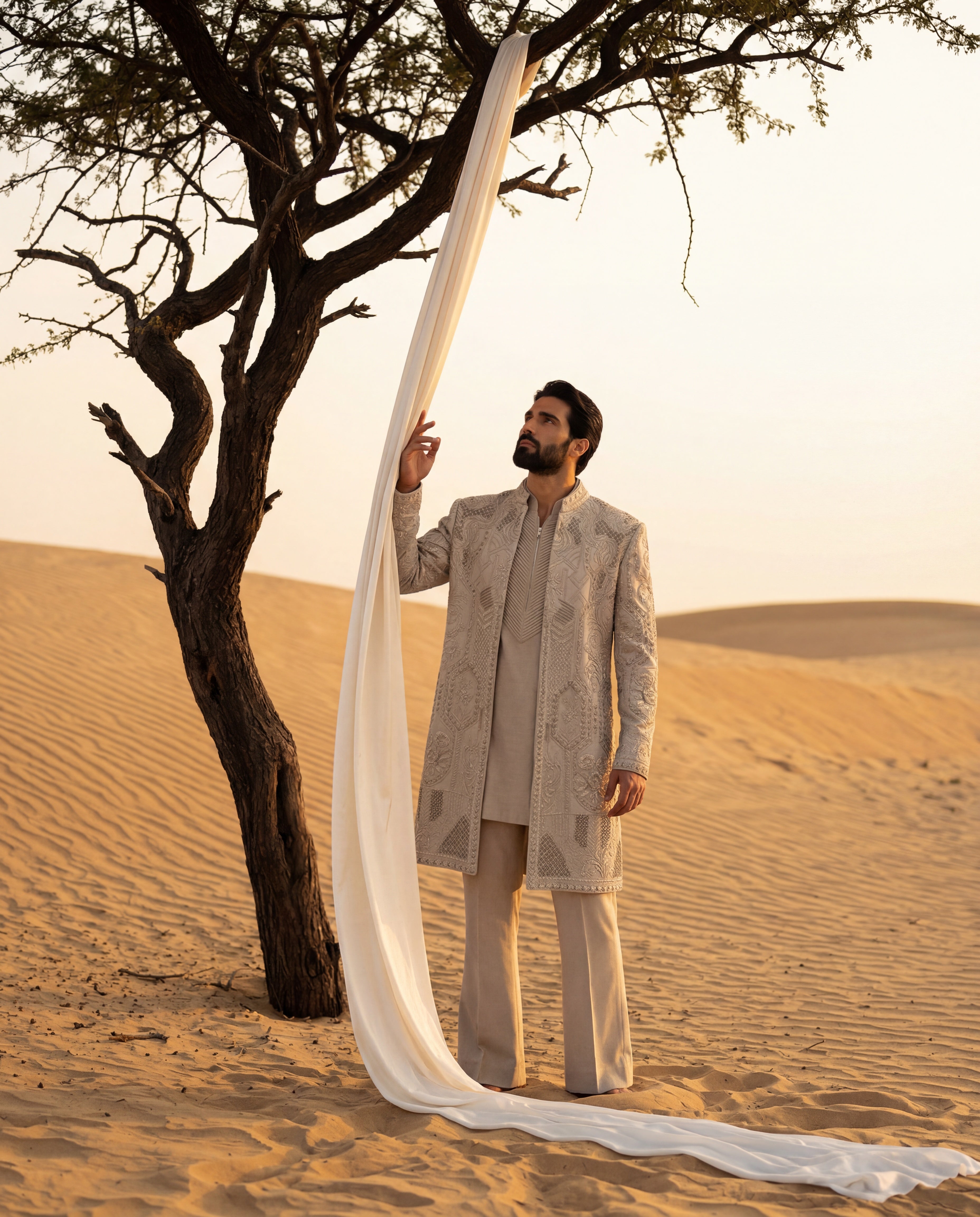 Khakhi Linen rayon long indowestern jacket with textured monotone embroidery detailing, paired with a pintuck kurta with front pleat detailing, paired with matching linen rayon pants.