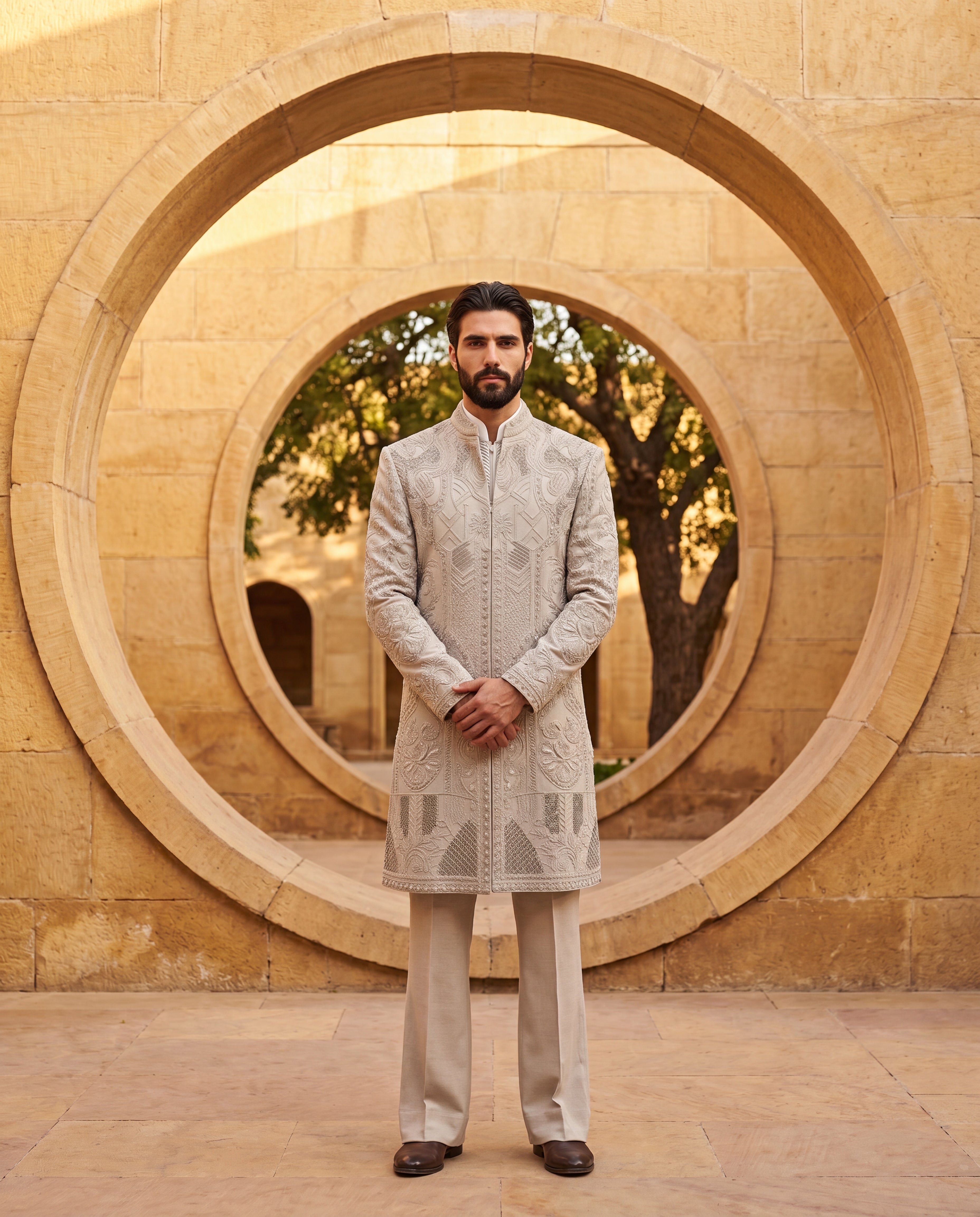 Khakhi Linen rayon long indowestern jacket with textured monotone embroidery detailing, paired with a pintuck kurta with front pleat detailing, paired with matching linen rayon pants.