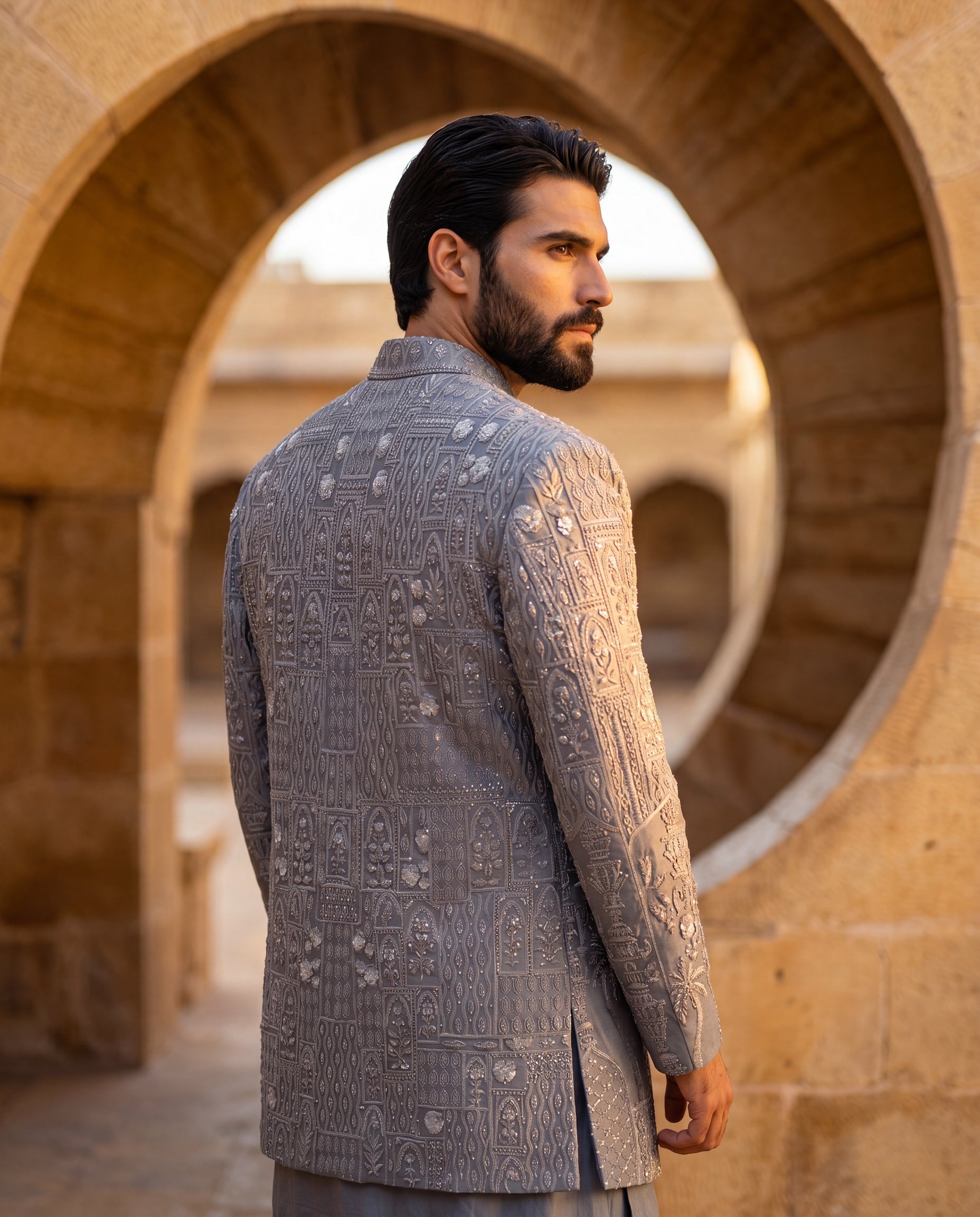 Grey Linen rayon Indo-Western jacket with monoton embroidery detailing, paired with a pleated neckline kurta and matching linen rayon pants.