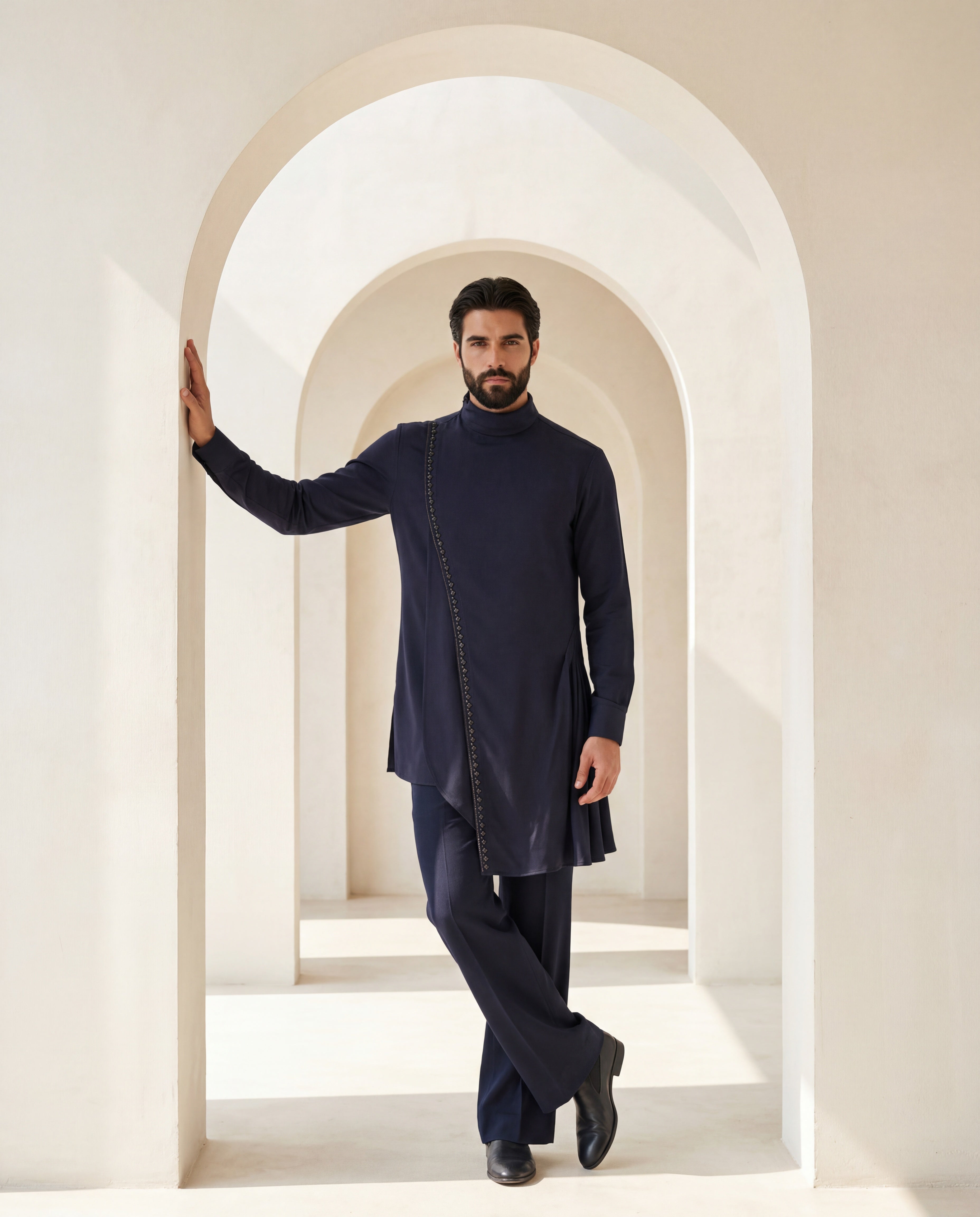 Navy blue asymmetric cut knit kurta with metallic embroidered detailing, paired with matching knit palazzo.