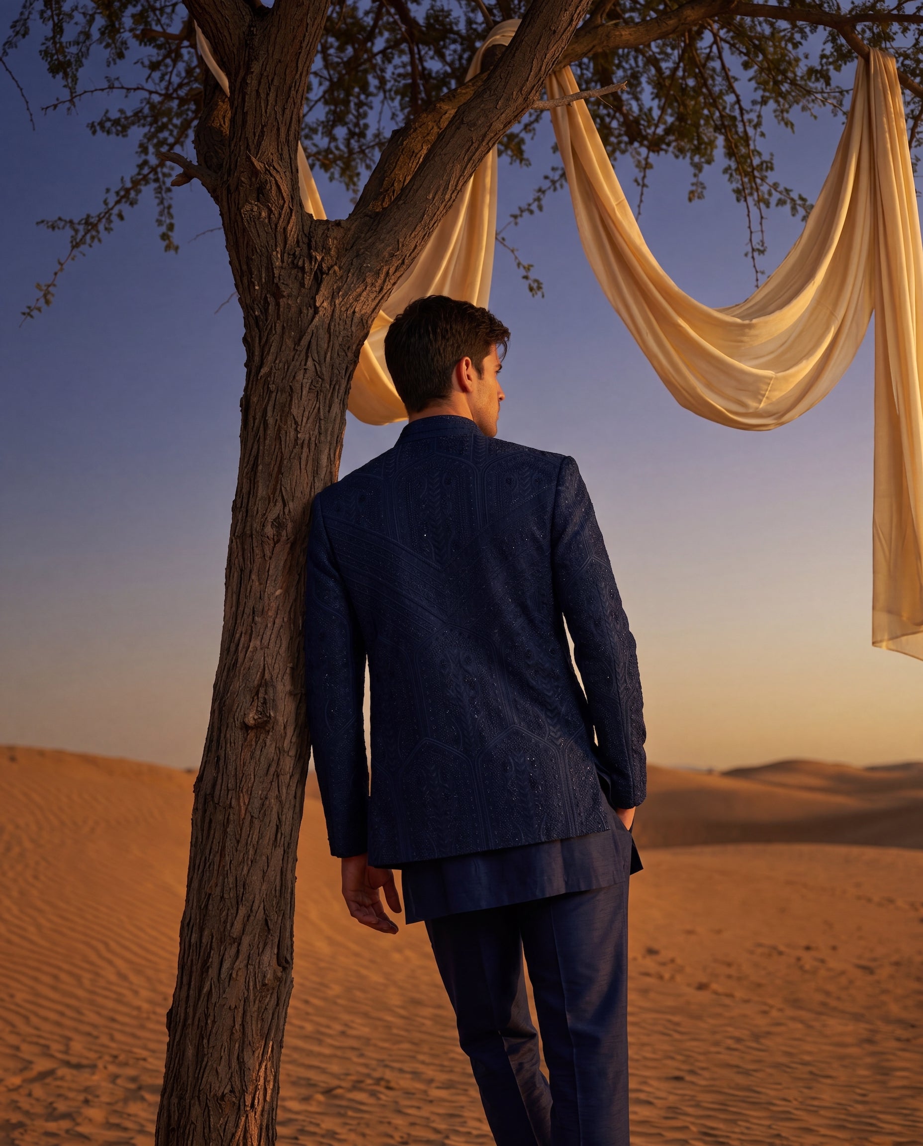 Navy blue Textured knit Indo-Western jacket with monotone embroidery detailing, paired with a cotton modal kurta and matching knit pants.