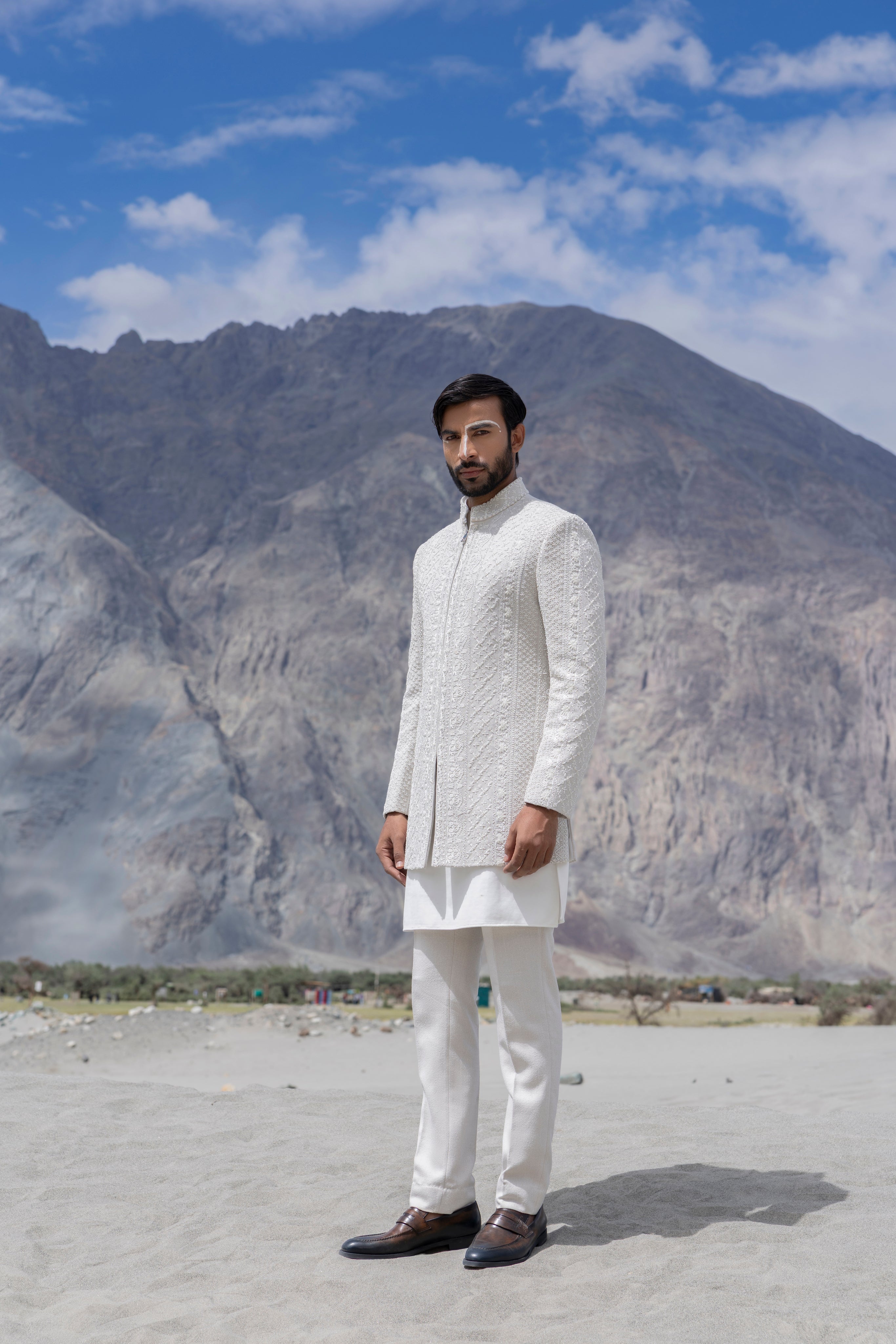 Ivoy indowestern jacket with front zipper and monotone hand-embroidery paired with a matching kurta and pants.