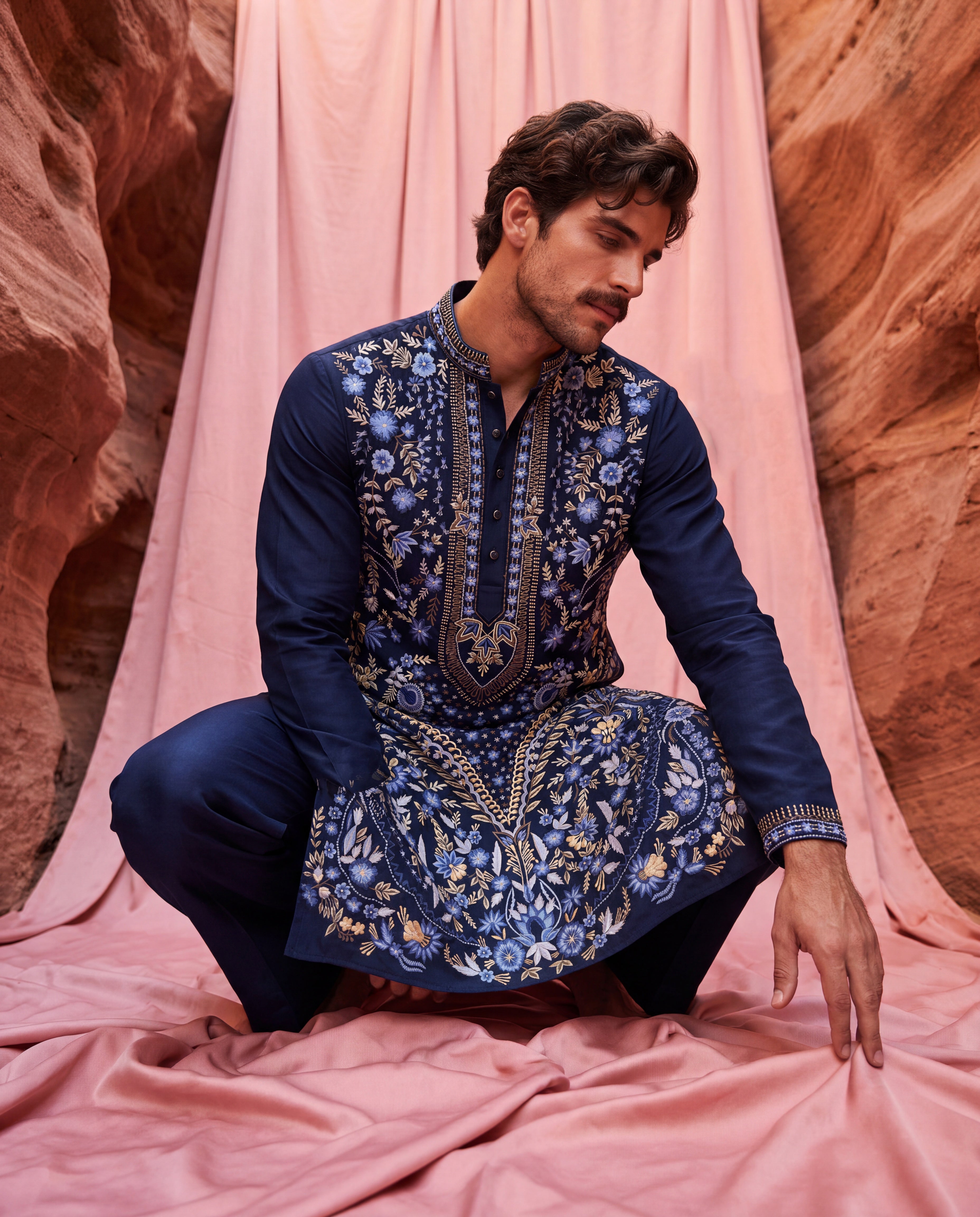 Navy blue knit kurta with intricate multi-coloured embroidered detailing, paired with matching knit palazzo.